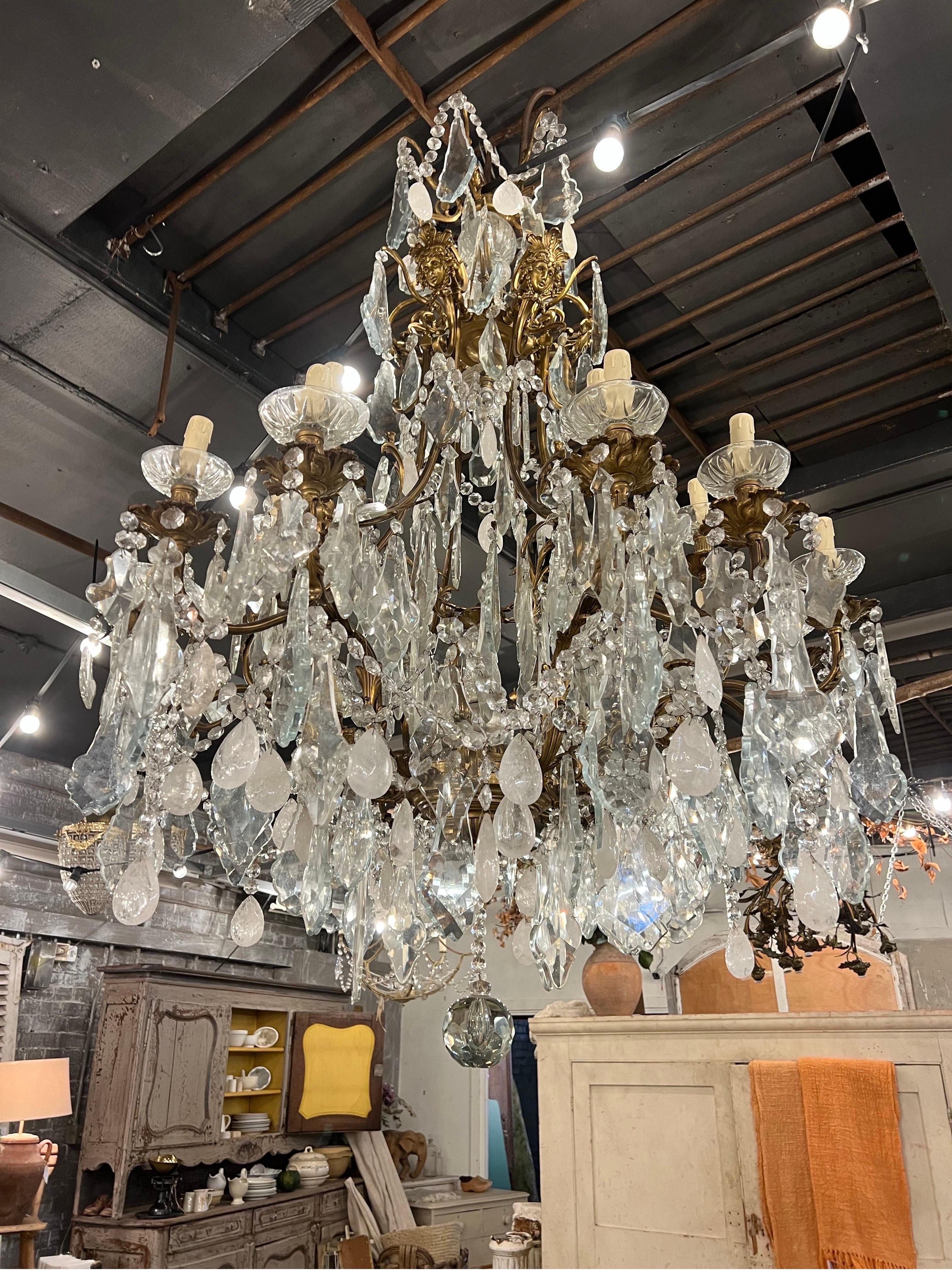 Elevate your home decor with a stunning large bronze rock crystal French chandelier. This exquisite piece features a luxurious design with intricate bronze detailing and shimmering rock crystal accents that will add a touch of elegance to any