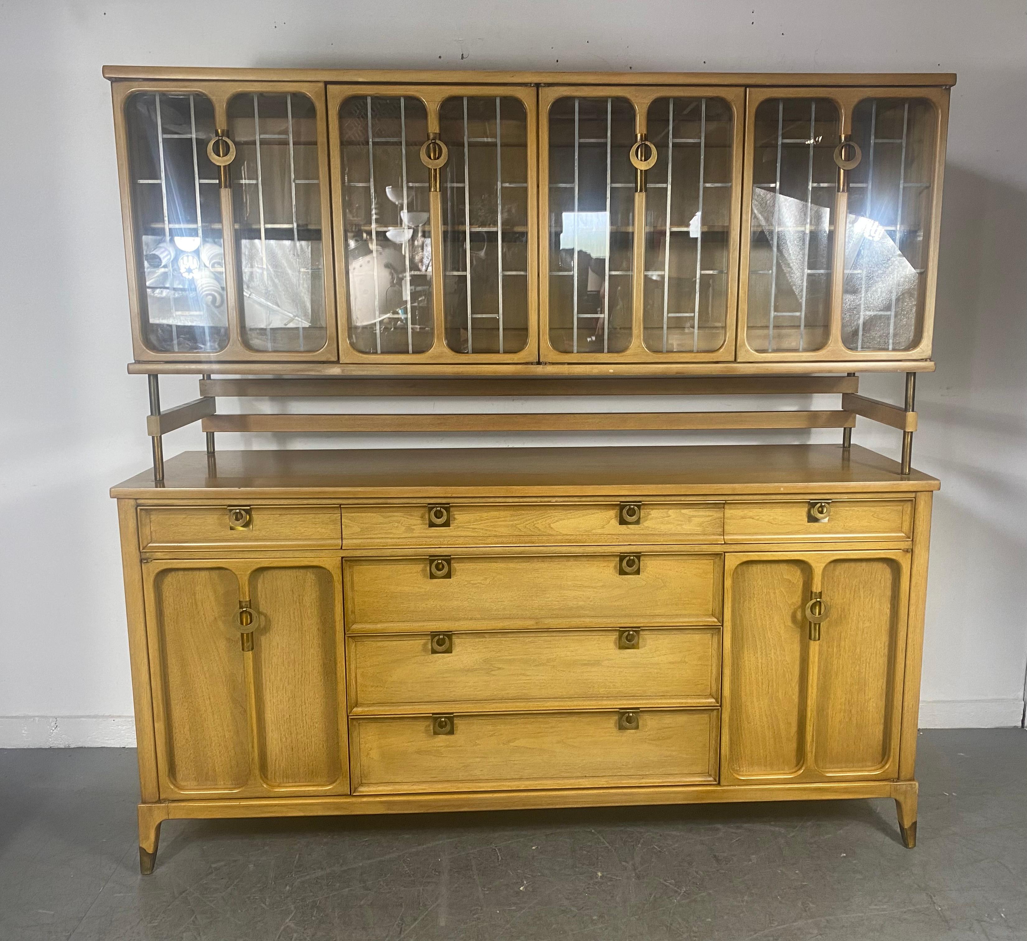Stunning 2-piece modernist cabinet by William Hinn for White Fine Furniture.. Superior quality and construction.. dove-tail joinery. Amazing brass hardware....Works well as two separate cabinets,, Unusual folding stand holds top leaded glass