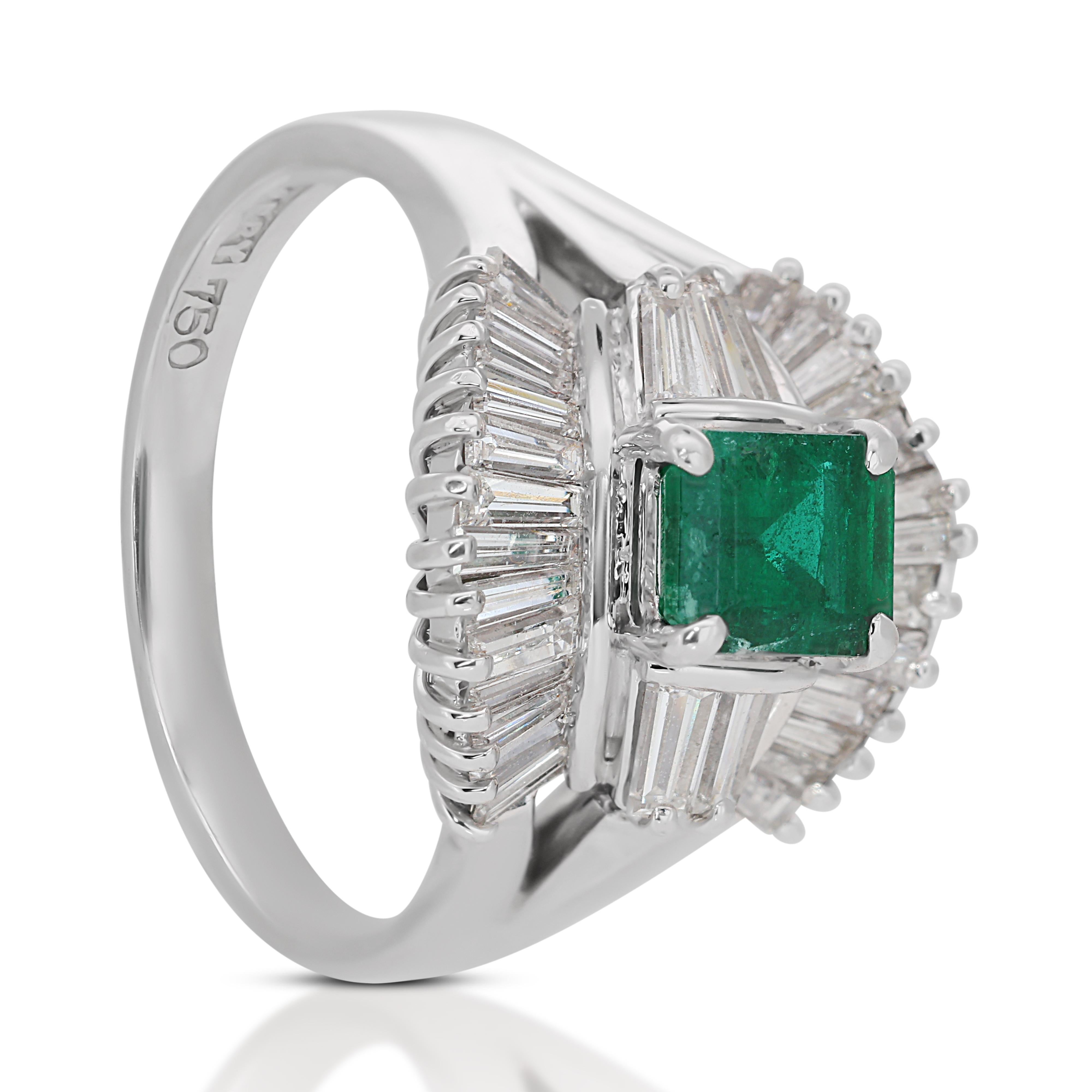 Stunning 2.08ct Emerald and Diamonds Halo Ring in 18k White Gold - IGI Certified

This exquisite halo ring in 18k white gold features a dazzling emerald-cut emerald as the main stone, weighing 0.70-carat. The vibrant green hue of the emerald adds a