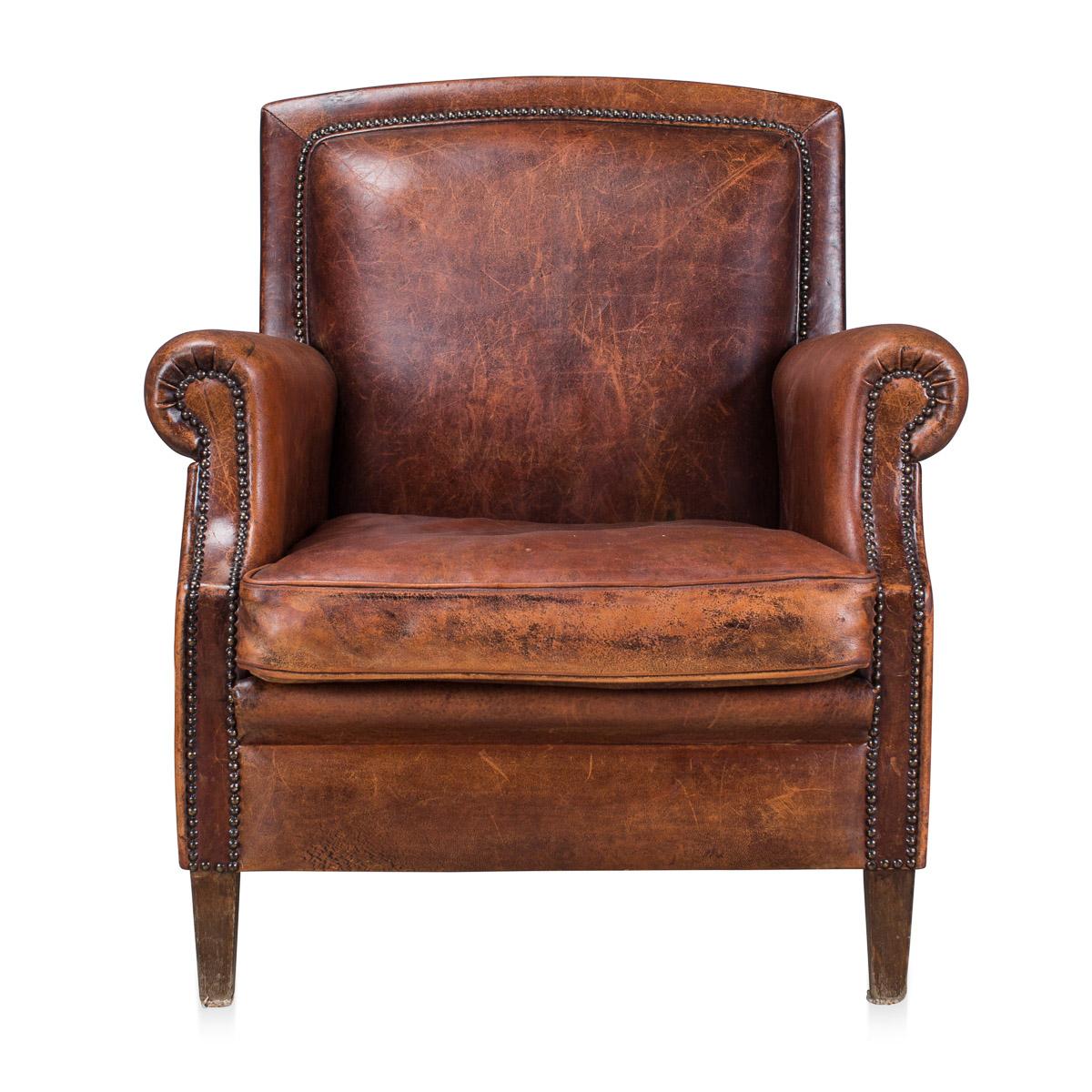 A wonderful sheepskin leather armchair, mid-late 20th century, manufactured in Holland and of the finest quality with great patina, removable cushion with studded backrest.
 
Condition:

In great condition - some scuffs and wear consistent with