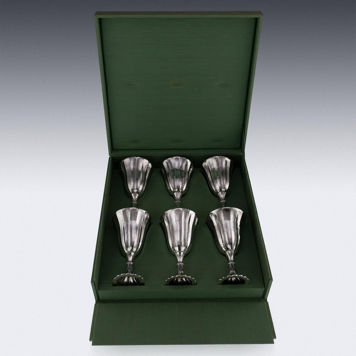 Description

Stunning 20th century Buccellati solid silver set of six large wine goblets, magnificent size and weight, lightly spot-hammered with fluted bowls and bases, cast beaded base rims, set comes in its original retail case. Hallmarked on