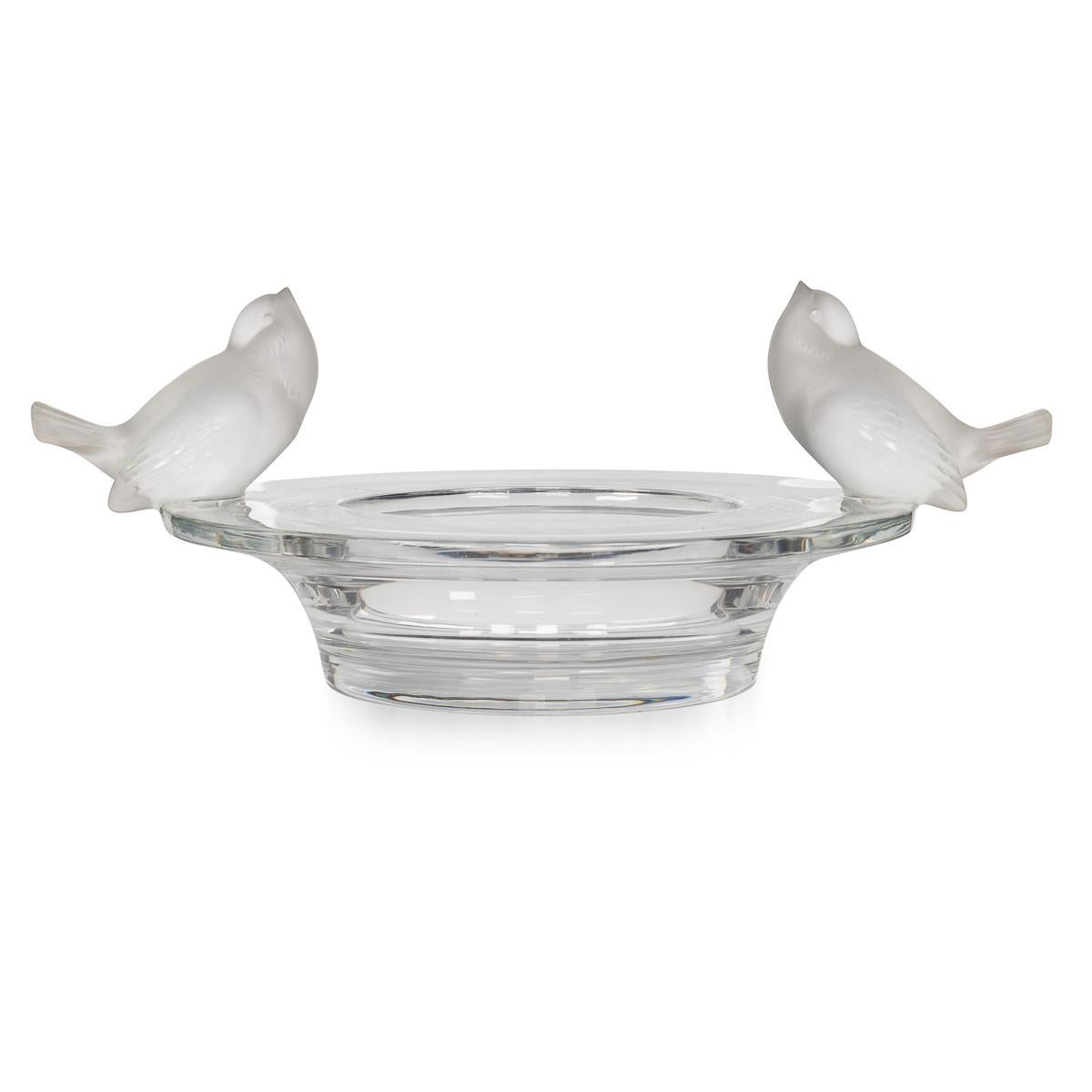This exquisite decorative cup, titled “Deux Moineaux Moqueurs” (“Two Mocking Sparrows”), was crafted in France in the latter part of the 20th century and bears the distinguished Lalique signature. Fashioned from frosted satin–finish crystal and