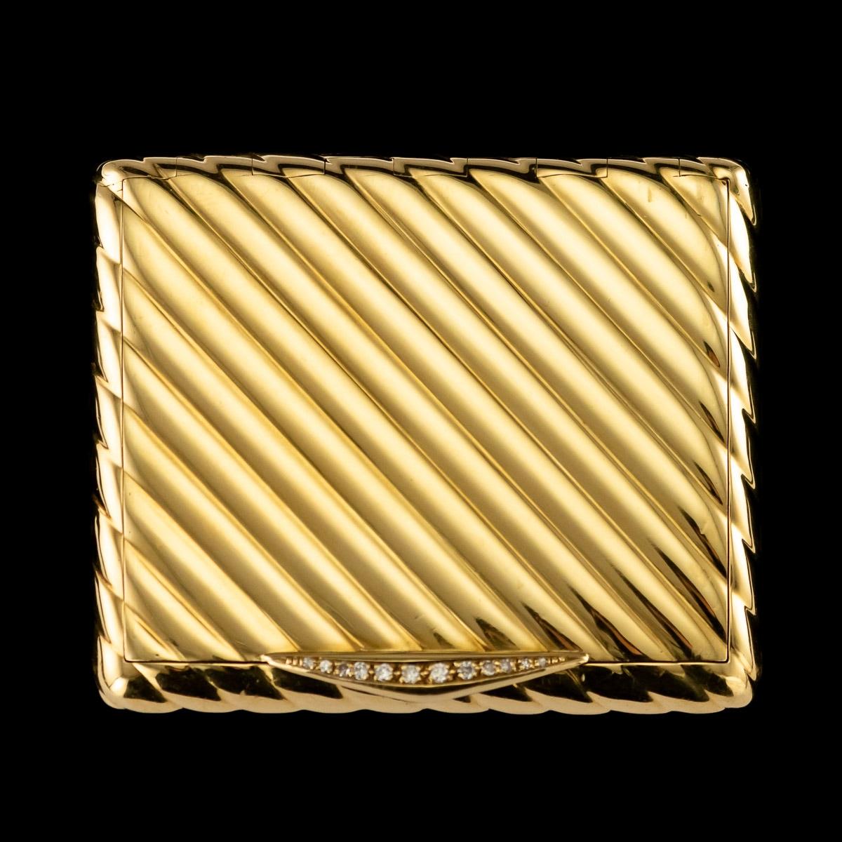 Stunning 20th century 18-karat gold and diamond compact, cushion shape, with a reeded design and a large diamond set thumb-piece. Hallmarked French small gold guarantee mark and 18-karat (owl, 750 standard), Signed Van Cleef & Arpels, NY inventory