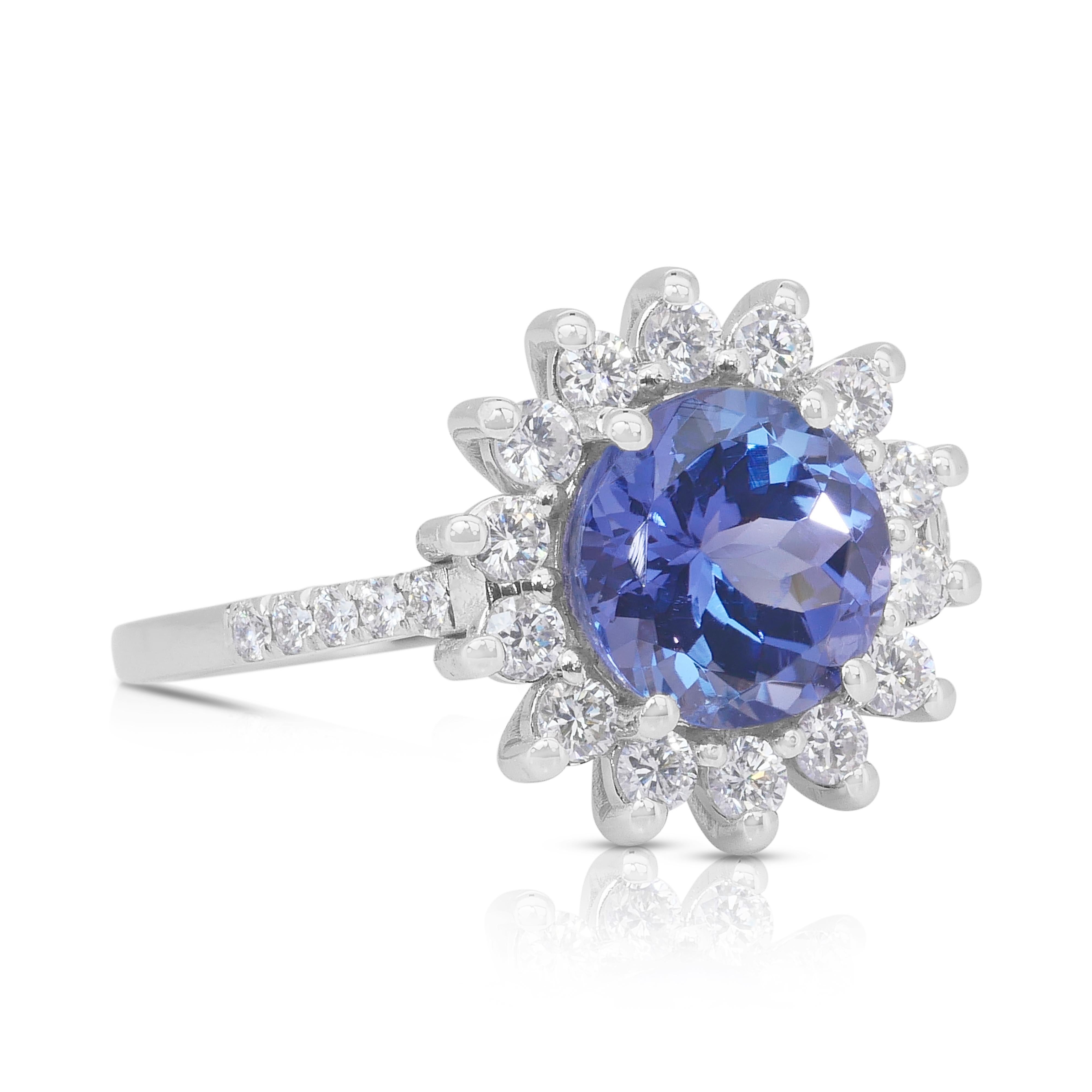 Stunning 2.71ct Tanzanite and Diamonds Cluster Ring in 18k White Gold - IGI Certified

Indulge in the captivating allure of this exquisite 18K white gold cluster ring, featuring a stunning 2.01ct round tanzanite. Its rich violetish-blue hue shimmers