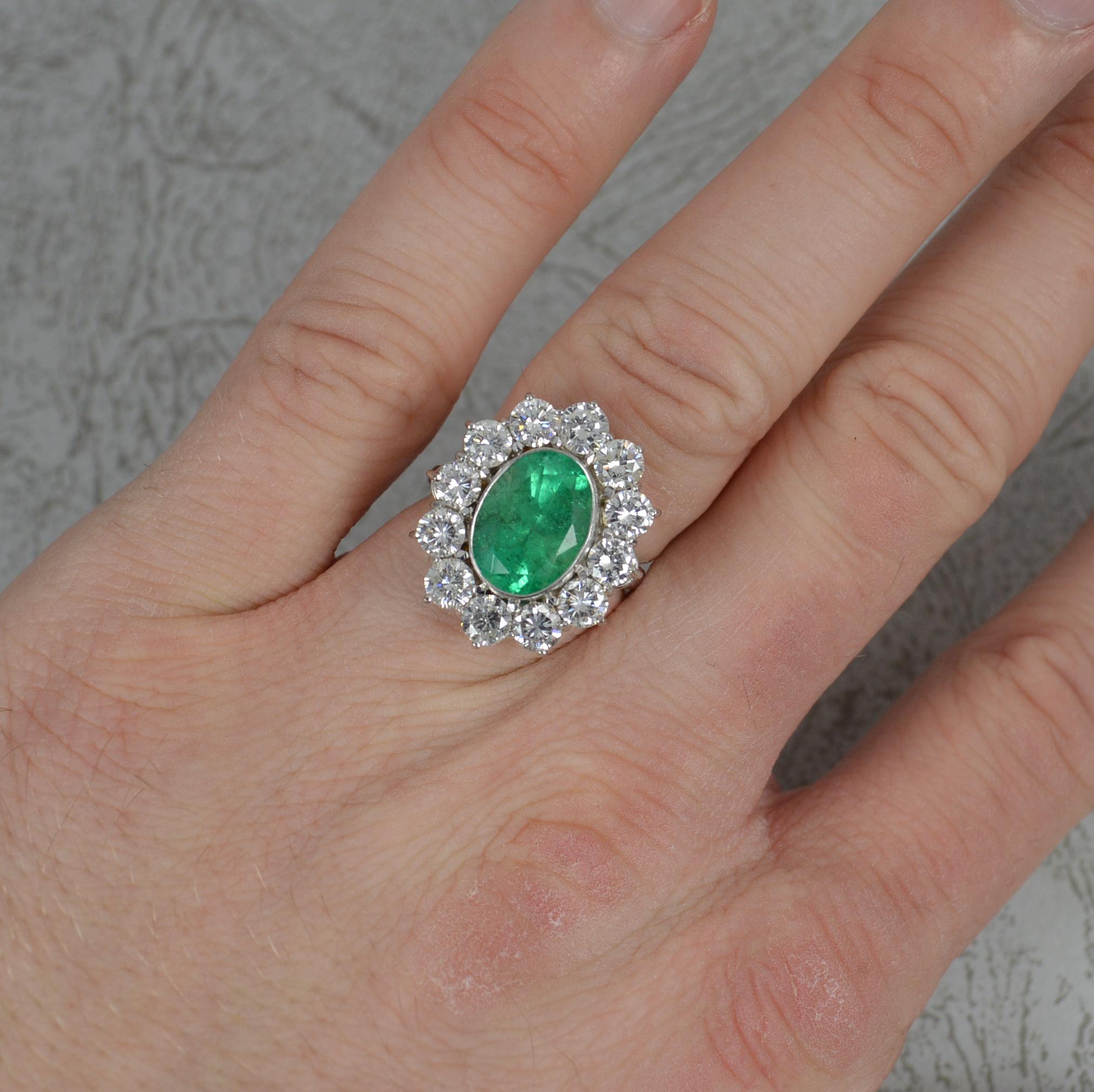 A stunning natural Emerald and Diamond ring.
Modelled in 950 grade platinum.
Designed with an oval cut emerald to centre in full grain bezel setting. 3.25cts. Surrounding are twelve round brilliant cut diamonds to total approx 2.00 carats. Clean,