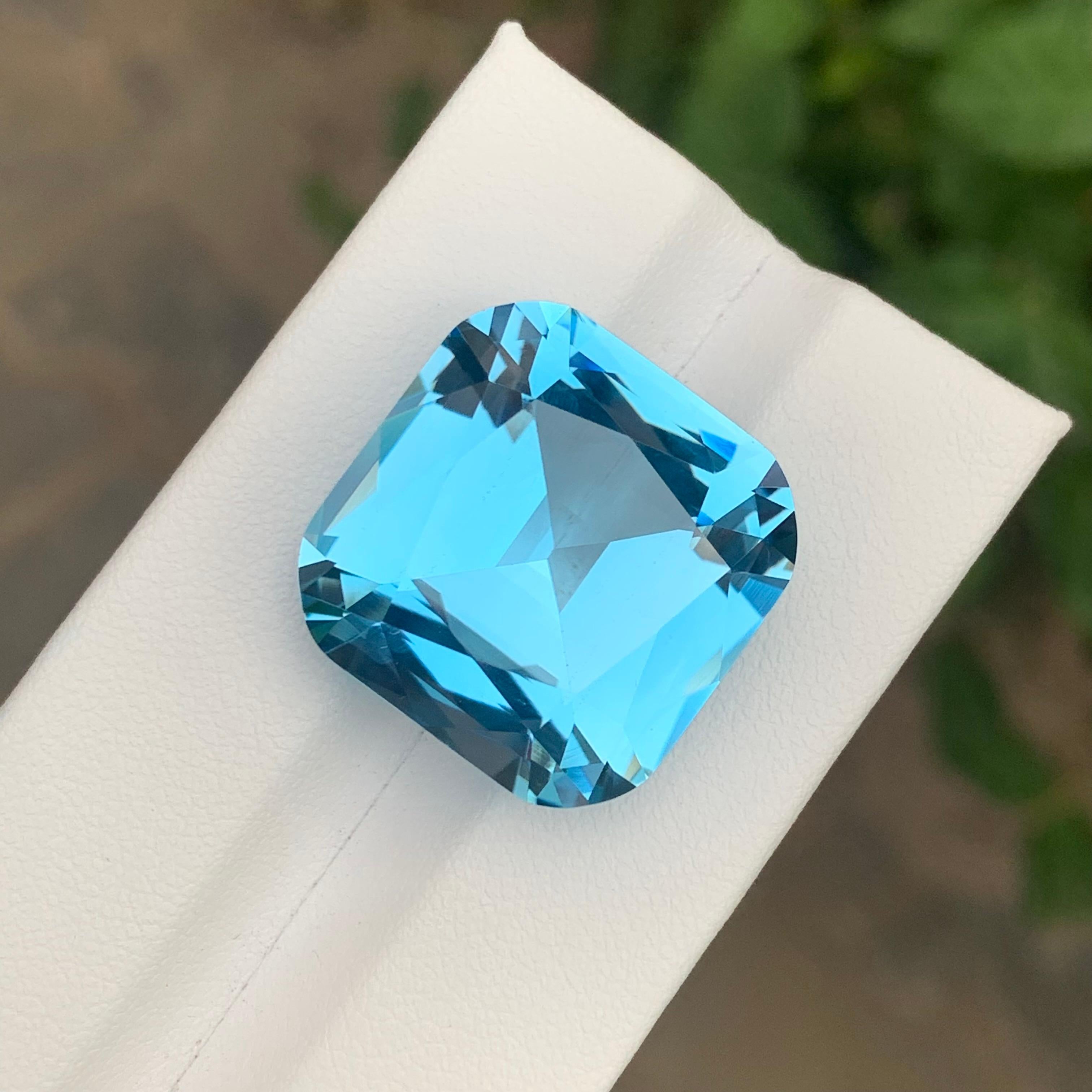 Faceted Sky Blue Topaz
Weight: 34.40 Carats
Dimension: 20x19.7x11.9 Mm
Origin: Brazil
Shape: Cushion
Color: Blue
Certificate: On Customer Demand 
Sky Blue Topaz (250 Words)

Sky blue topaz is a beautiful and highly sought-after gemstone known for