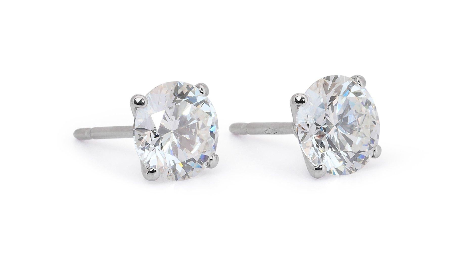 Stunning 4.03ct Triple Excellent Ideal Cut Diamonds Stud Earrings in 18k White Gold - GIA Certified

Elevate your elegance with these stunning 18k white gold diamond stud earrings, featuring a total of 4.03 carats of triple excellent ideal-cut
