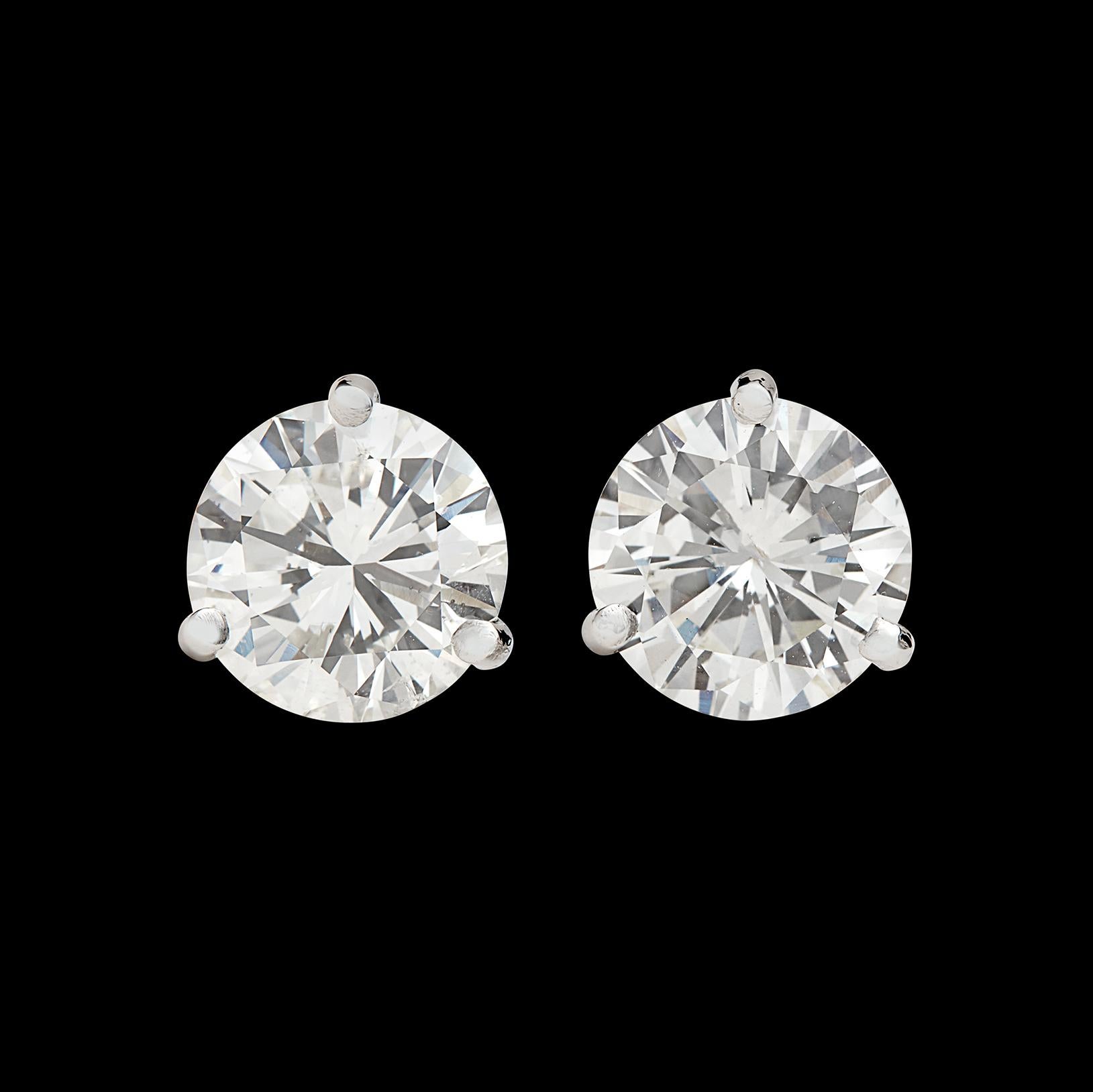Conversations will stop when wearing theses earrings! Set in three-prong platinum mounts, the 2.02 ct round brilliant-cut diamonds average H-I color and SI2 clarity, and together weigh a significant 4.04 carats. These bright and sparkling headlights