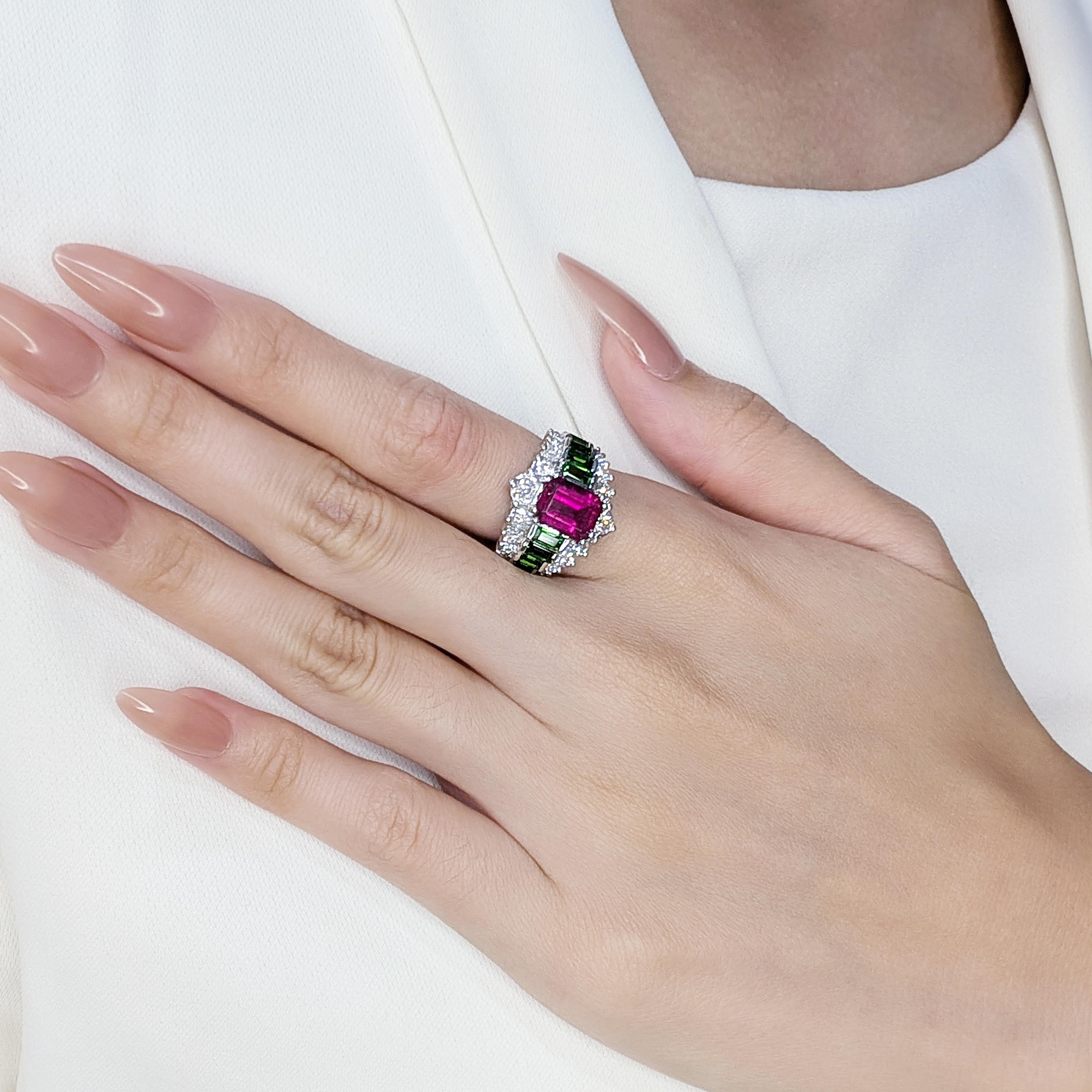 This pre-owned ring is a captivating blend of bold colors and refined elegance, crafted in luxurious 18K white gold. The centerpiece is a stunning 2.2ct emerald-cut red tourmaline, radiating vibrant sophistication. Complementing the design are 10