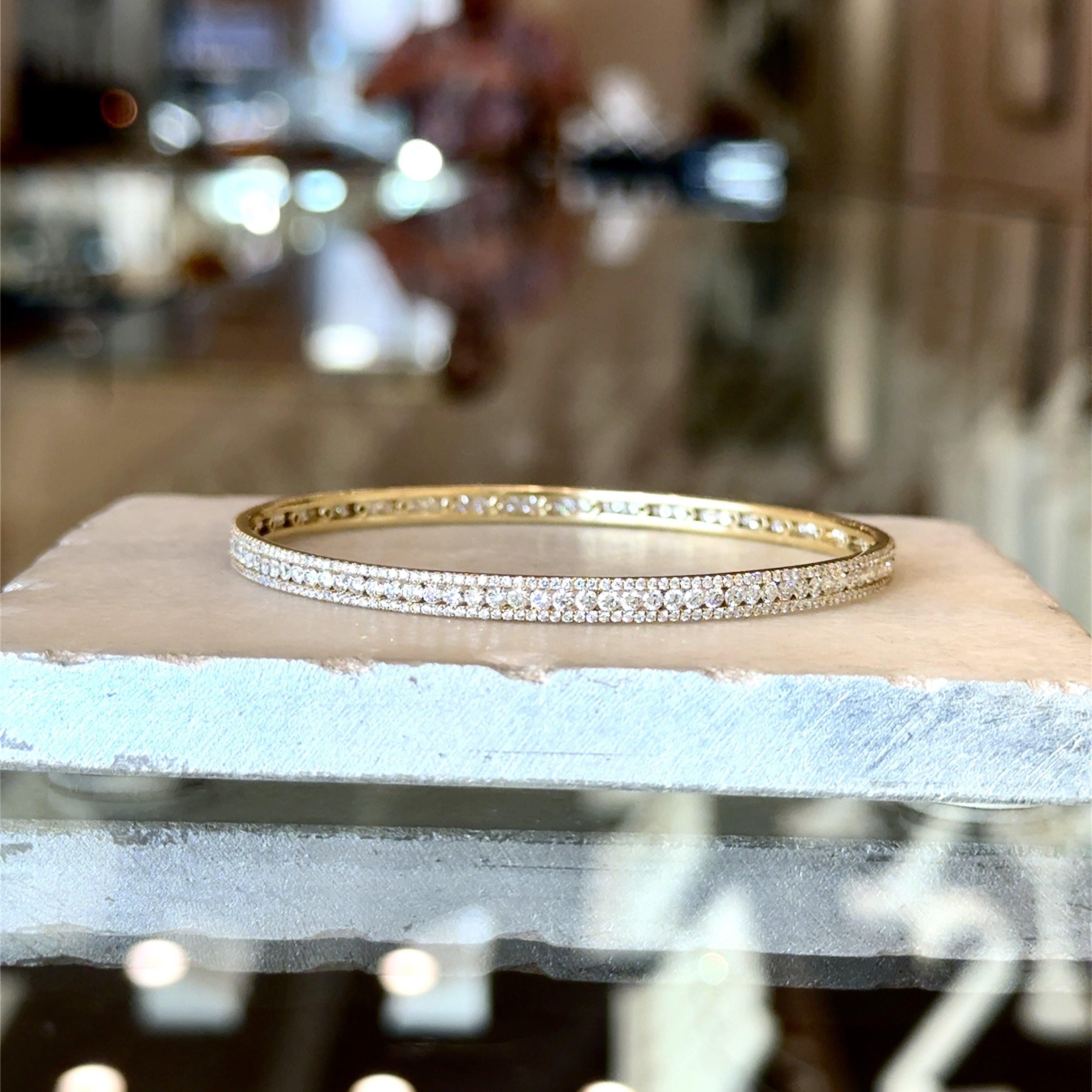 Stunning Diamond Bangle
4.79ct Brilliant Round Natural Diamonds
F-G Color VS-SI Clarity 
4mm Wide
7.5 Inches Inner Circumference
2.5 Inches Across
12.3 grams 14kt Yellow Gold

Why we love it: This sparkling diamond bangle shimmers and catches the
