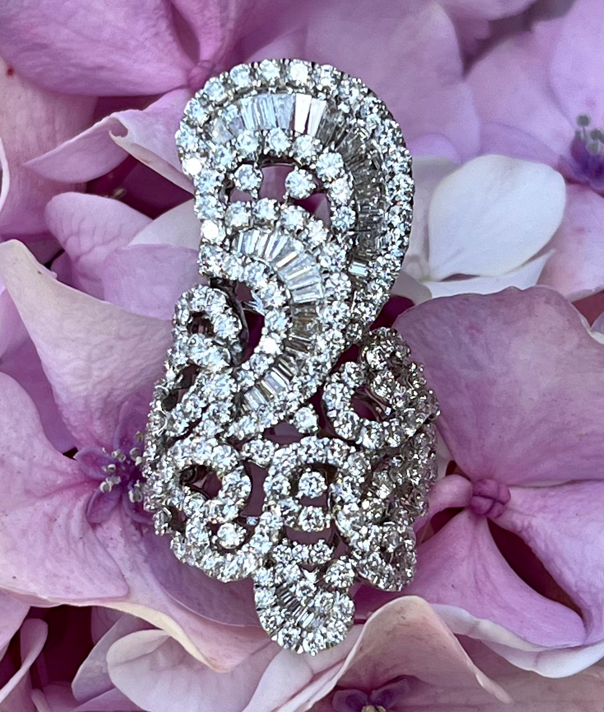 Stunning and very unique, swirling, arabesque design, hand-made 18 karat white gold diamond ring is designed with graceful, cascading, and sweeping tendrils and leaves and features approximately 166 prong set round brilliant diamonds and 43 baguette