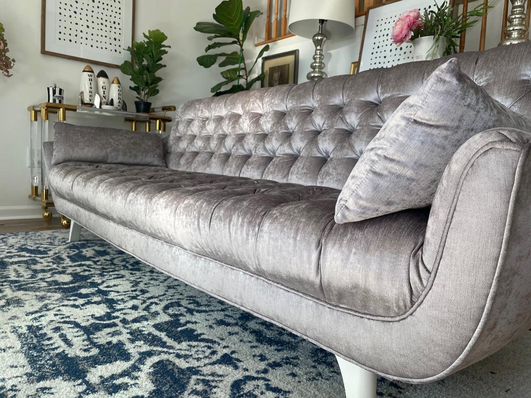 Stunning Adrian Pearsall button tufted sofa in the Hollywood Regency style. This piece has been meticulously restored 7 years ago with new high end shimmering silver grey velvet and newly lacquered white legs. Although the work was done several