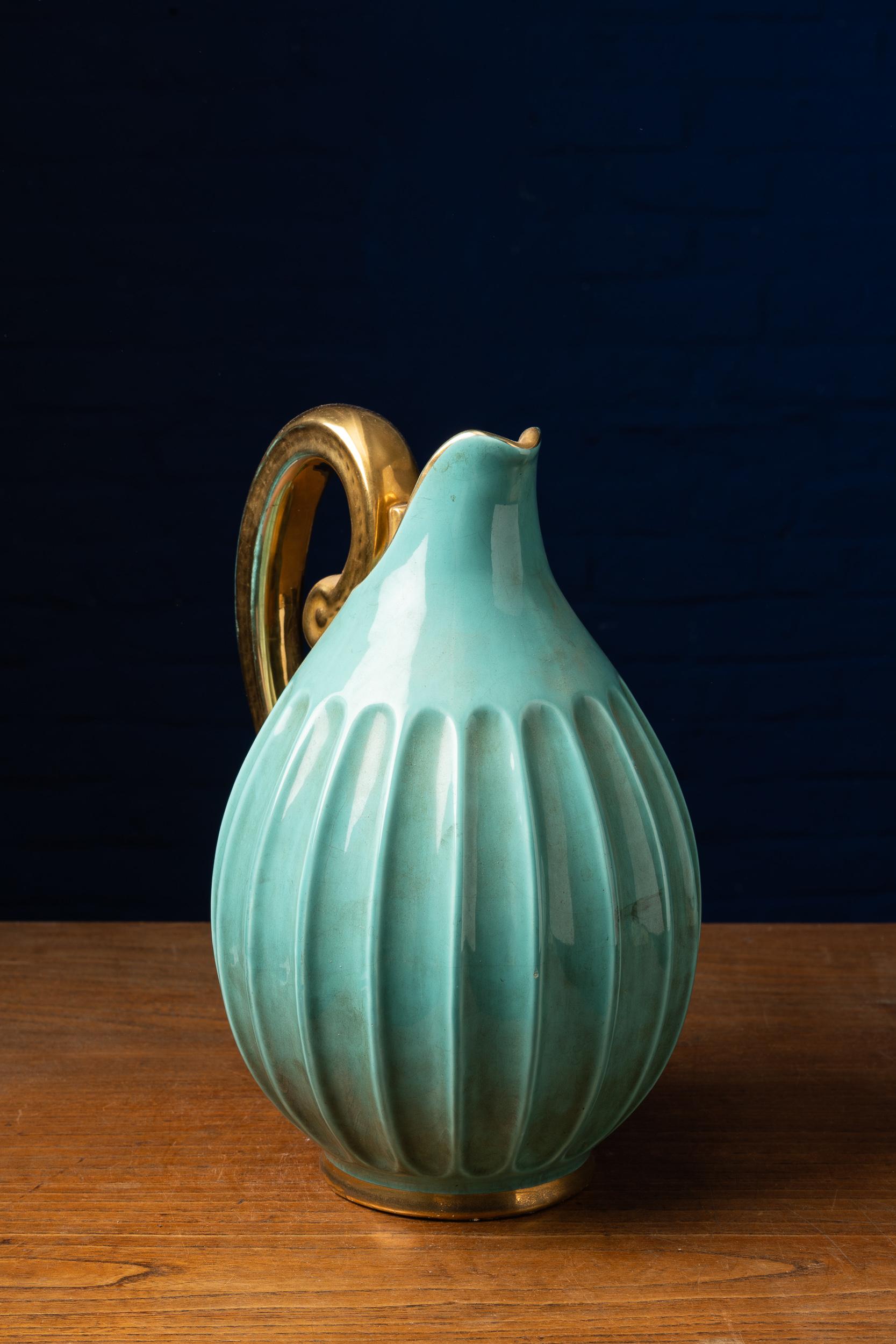 Gorgeous vintage ribbed ceramics vase with turquoise and gold glaze beautifully crafted by Belgian artist Alexandra Wemmel (1909-1964). This remarkable item is tagged on the bottom 