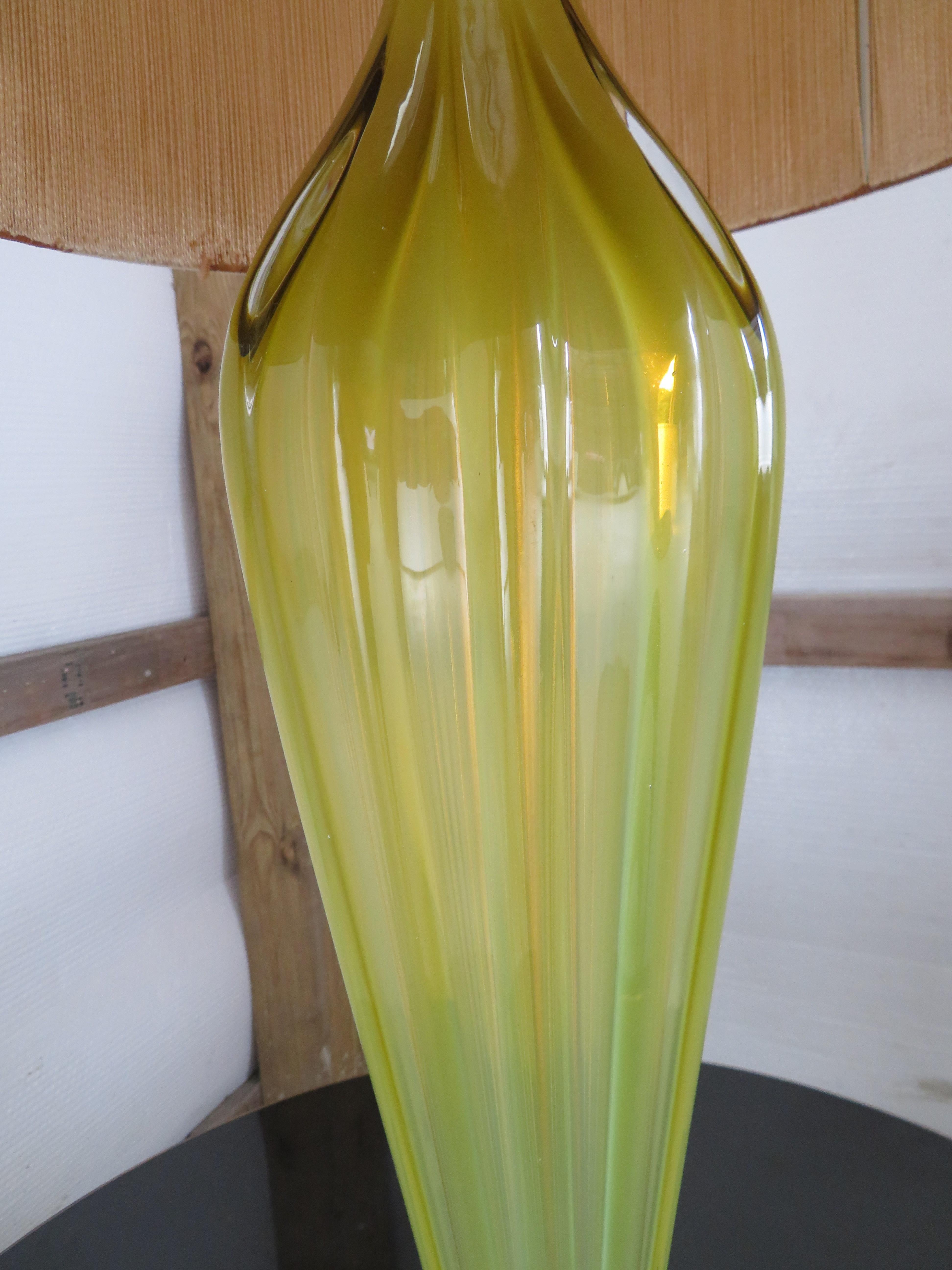 Stunning Alfredo Barbini opaline yellow ribbed Murano glass table lamp with gold flecks, circa 1950. We love the simplistic chunky walnut base! This lamp measures: 39