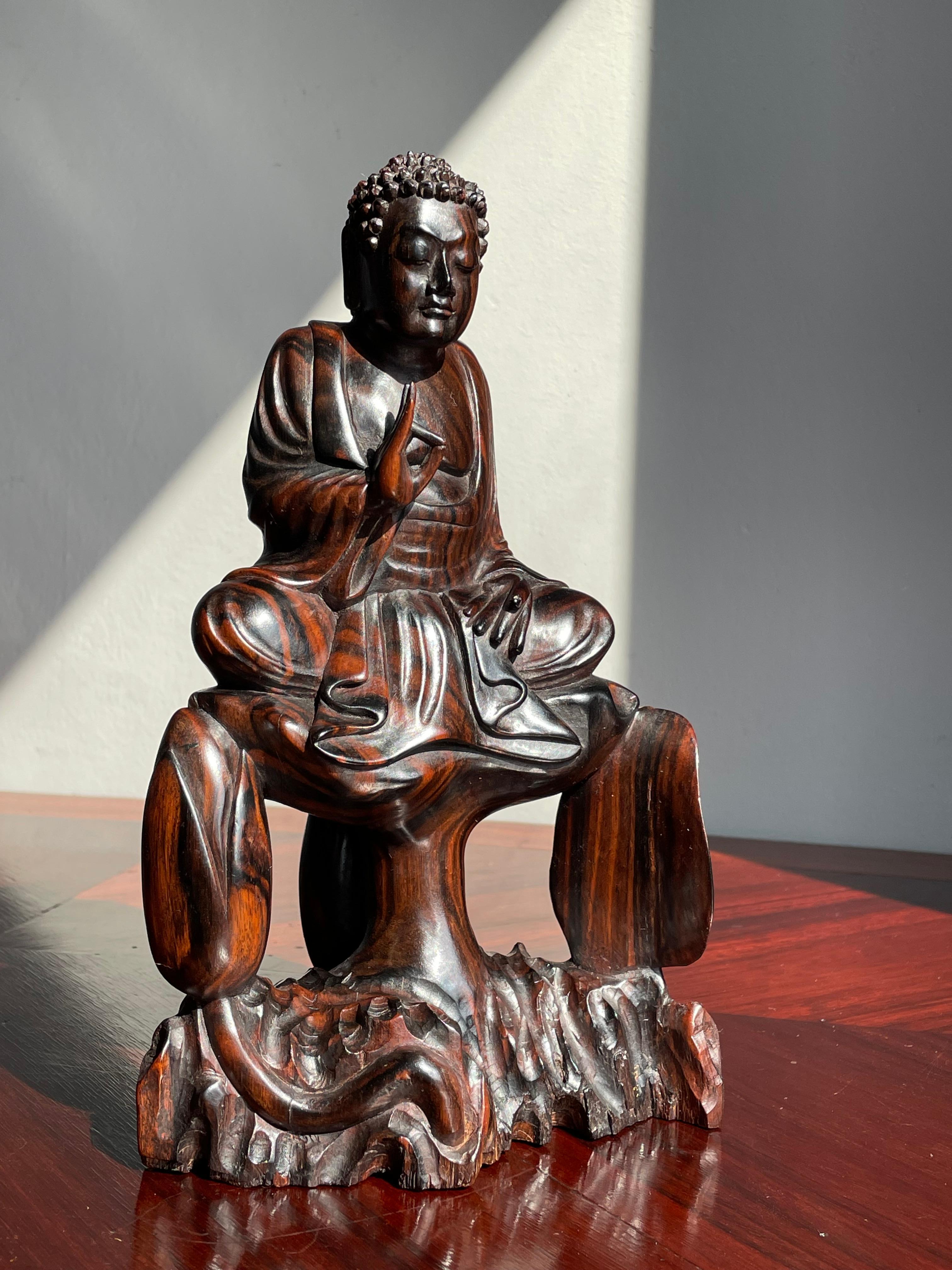 Unique on the worldwide web.

This beautifully excecuted sitting Buddha of infinate light is entirely handcarved out of one stunning piece of coromandel wood. The different warm shades in this expensive hardwood make this serene Buddha even more