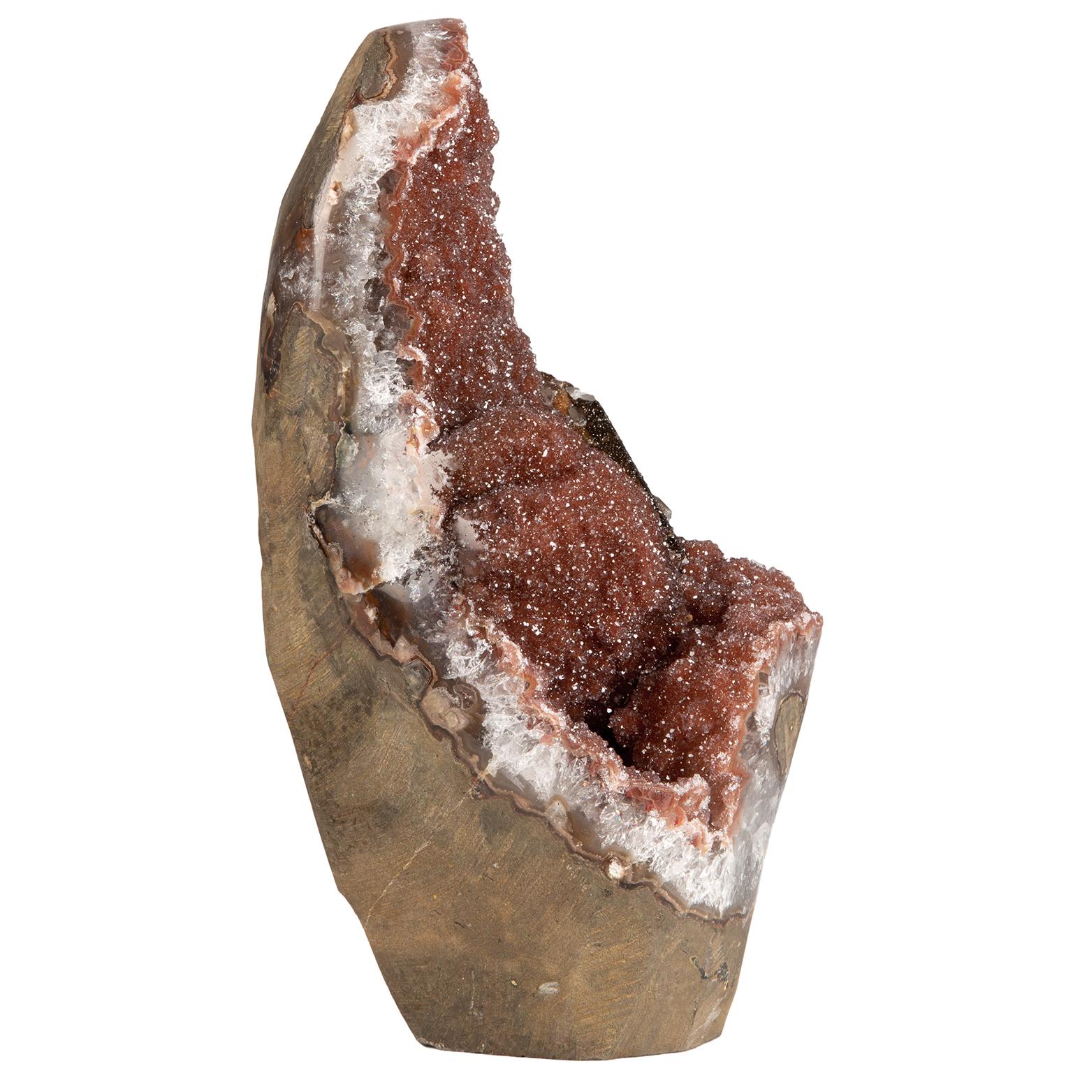 A very unusual and stunning formation with of a mix of minerals and beautiful fusion of colors.

This freestanding piece conserves part of the original geode and it is still possible to appreciate the basalt to the side and at the back in its
