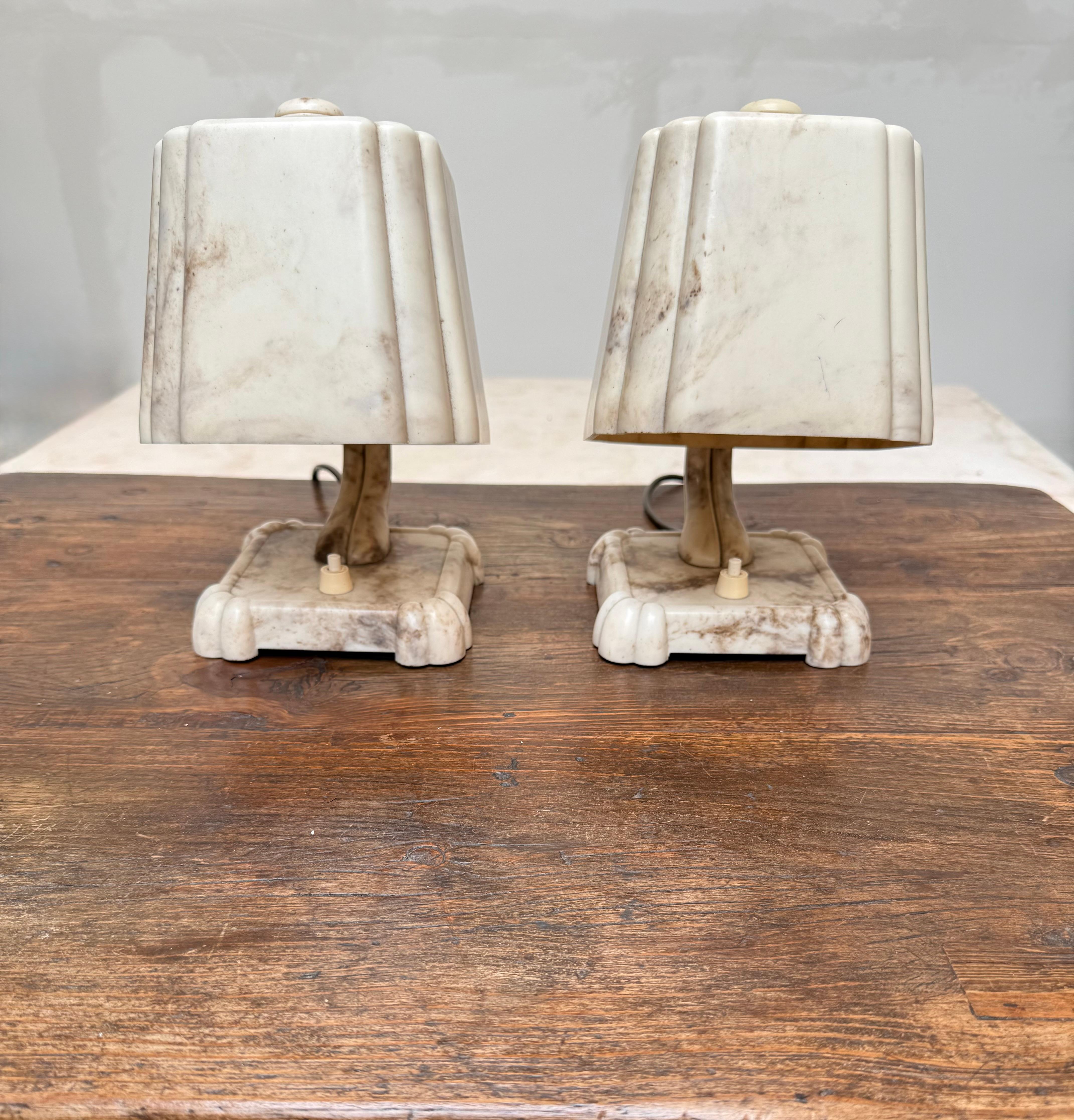 Rare pair of 1930s Art Deco bakelite table lamps with faux Marble finish,  rewired for U.S. use.

A spectacular and exceedingly rare matching pair of authentic 1930s Art Deco table lamps, masterfully crafted from genuine Bakelite. These sculptural