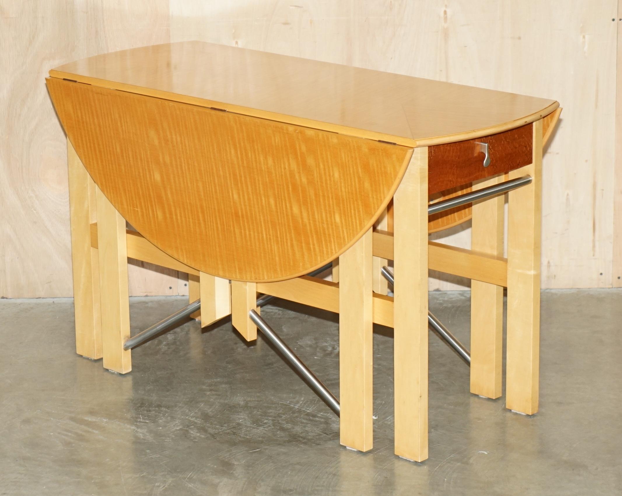 Royal House Antiques is delighted to offer for sale this sublime designer Andrew Varah Satinwood & Walnut round extending dining table with twin drawers

Please note the delivery fee listed is just a guide, it covers within the M25 only for the UK