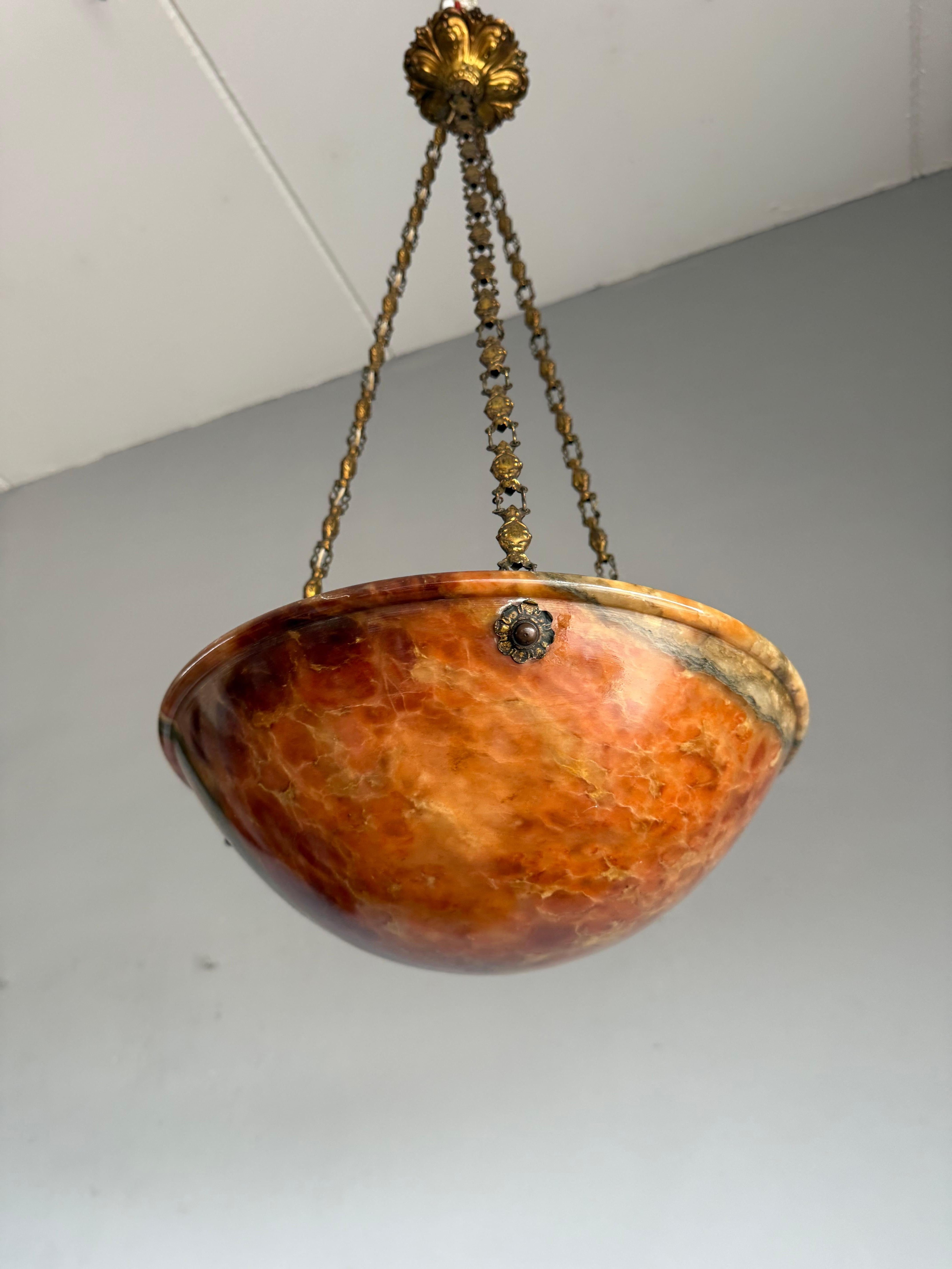 Rare 'Eternal Fire' Alabaster Pendant Light with Ornate Bronze & Brass Mount, France, Early 20th Century.

A rare and striking early 20th-century French alabaster pendant, this exceptional fixture showcases the dramatic beauty of richly veined