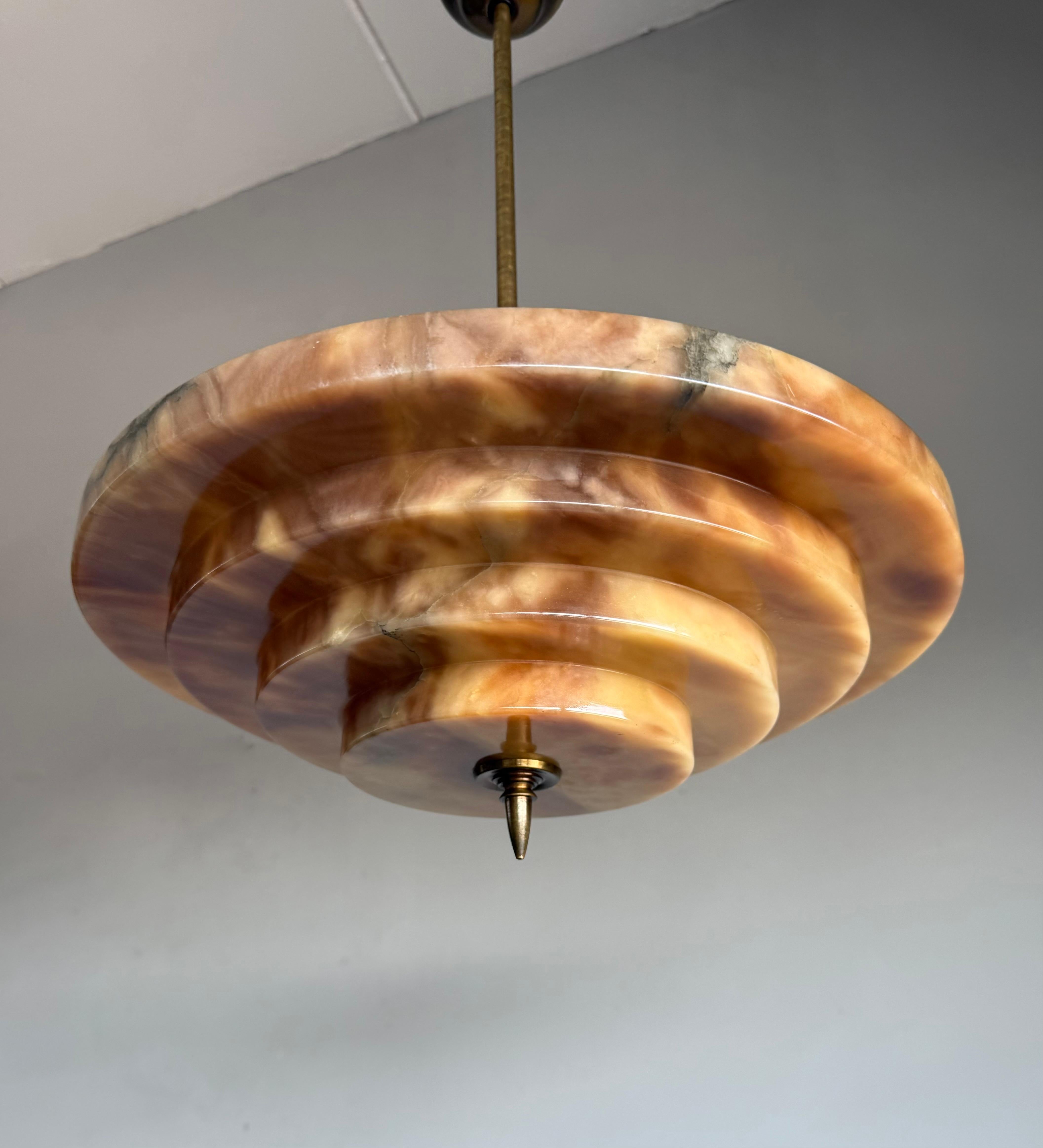 Great design and top quality made Art Deco 3-light alabaster pendant, ceiling light.

This early 1900s, layered alabaster pendant is pure Art Deco in design and the shape and colors make this one of the special alabaster lights we had the pleasure