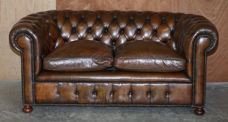 We are delighted to offer for sale this exceptionally rare original antique circa 1900 cigar brown leather Chesterfield club sofa in restored condition with feather filled cushions and custom made to order hand turned walnut bun feet 

A really
