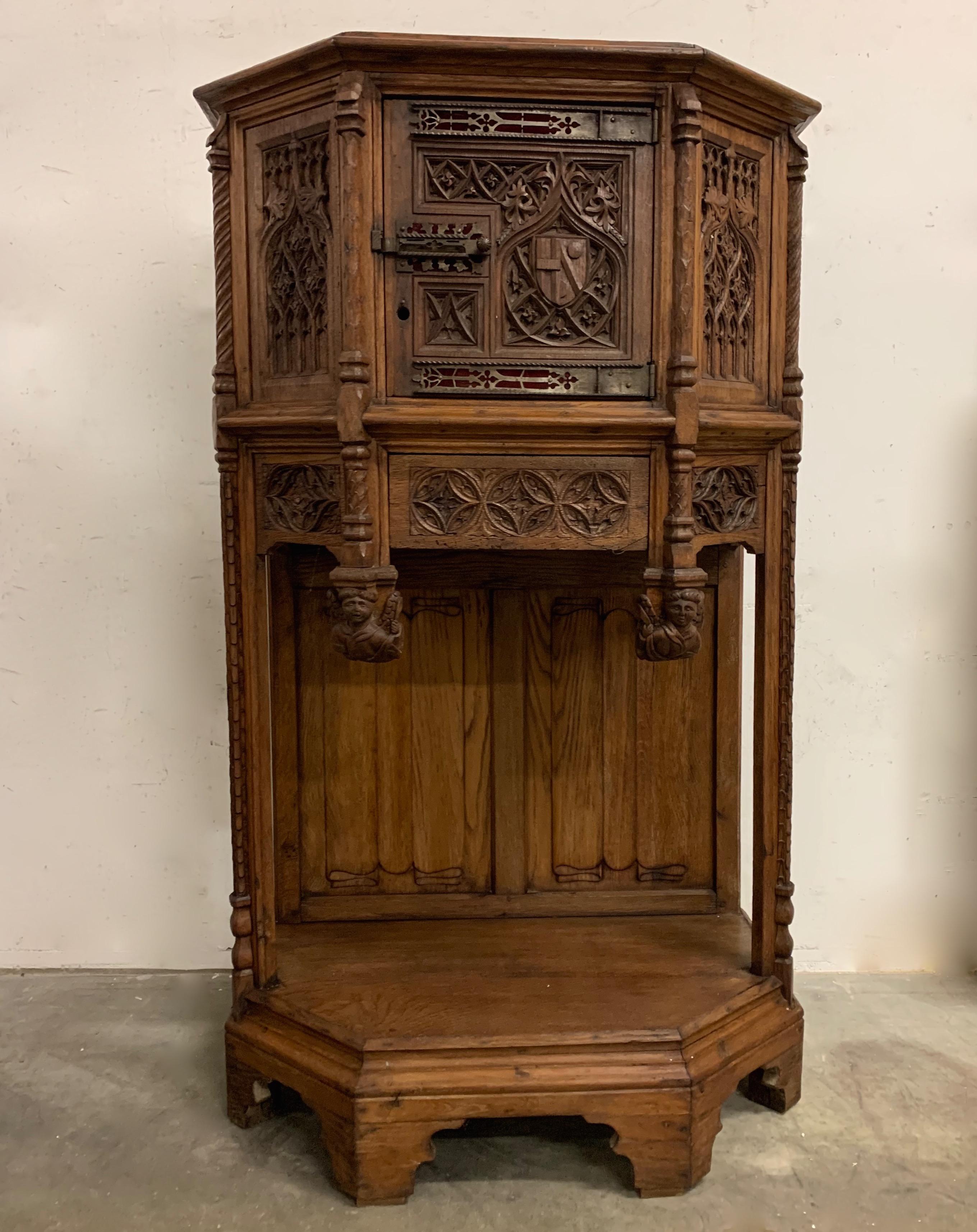 Another piece of Gothic Art furniture. This time with a special feature.

This handcrafted Gothic Revival cabinet or credenza with drawer from the late 19th century is actually made with the use of hand carved oak panels from the 18th century. These