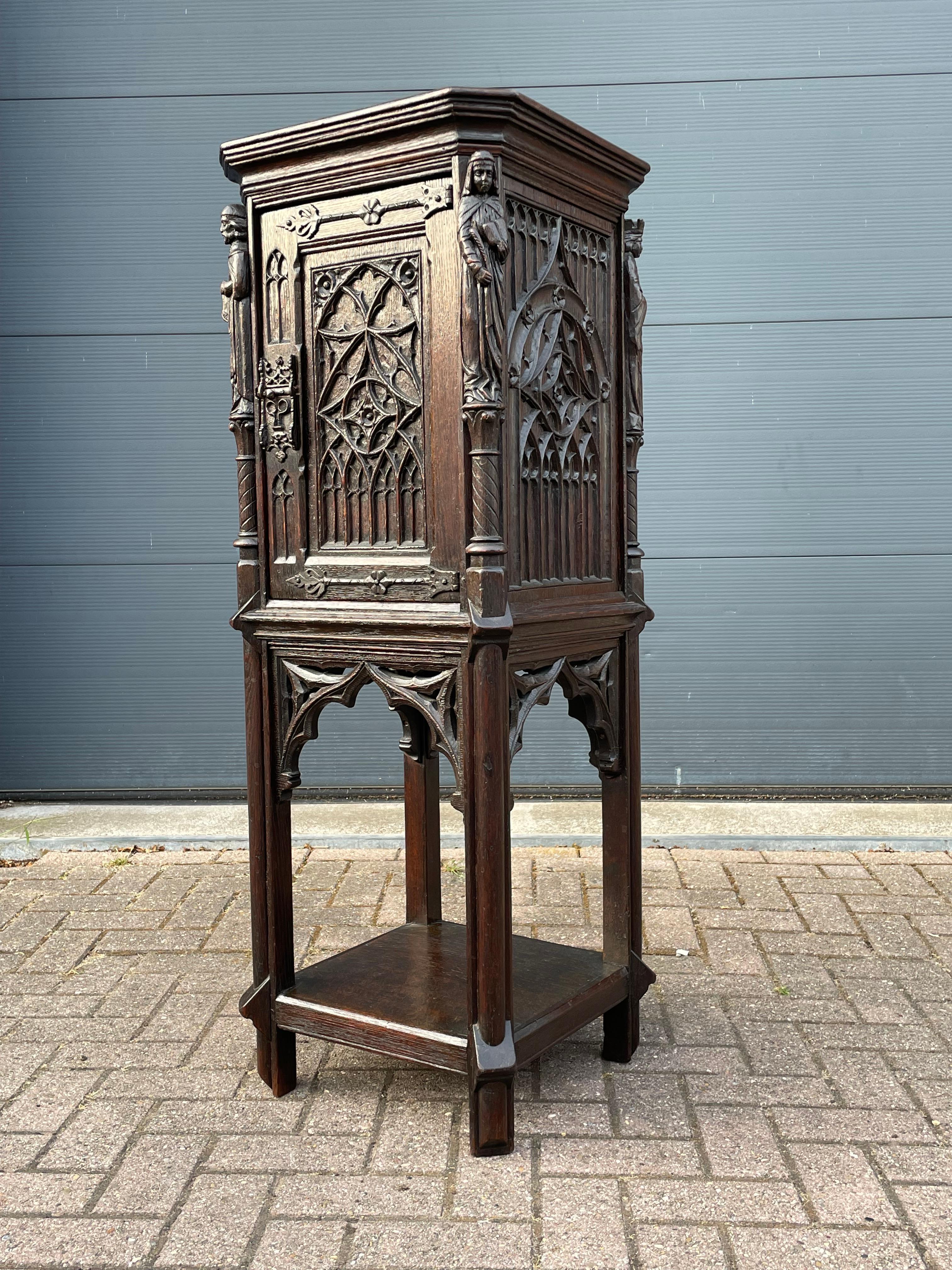 Marvelous, truly Medieval looking and practical Gothic Revival (drinks) cabinet and/or pedestal stand.

This rare Dutch Gothic cabinet is in excellent condition, it comes with some of the most amazing, church window-like, carved panels (all around)
