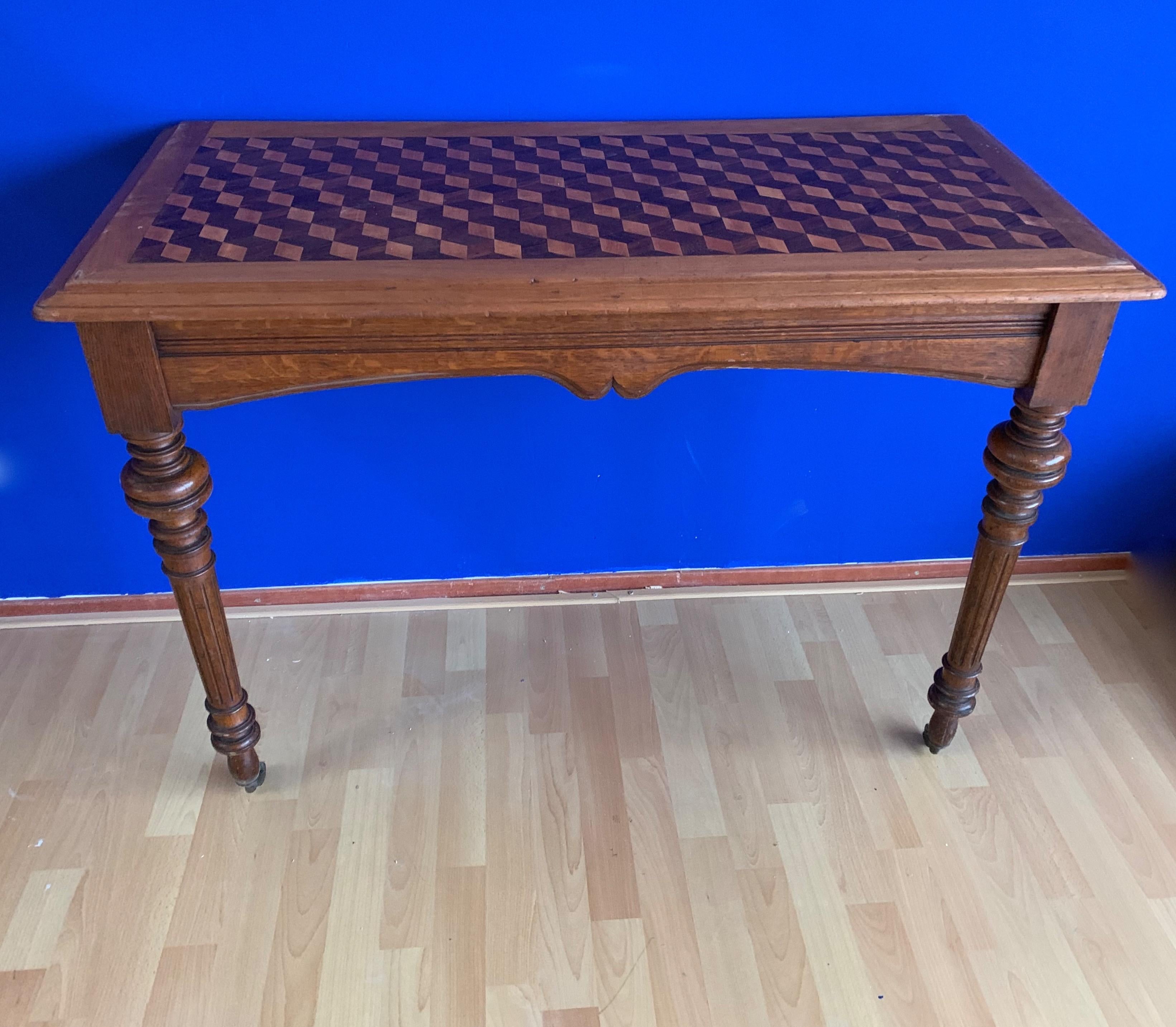 Beautiful antique parquetry table from circa 1880-1900.

Some people call the technique of these, amazingly inlaid cubical motifs parquetry and some call it marquetry. Any 19th century table with such top quality inlaid motifs with satinwood would