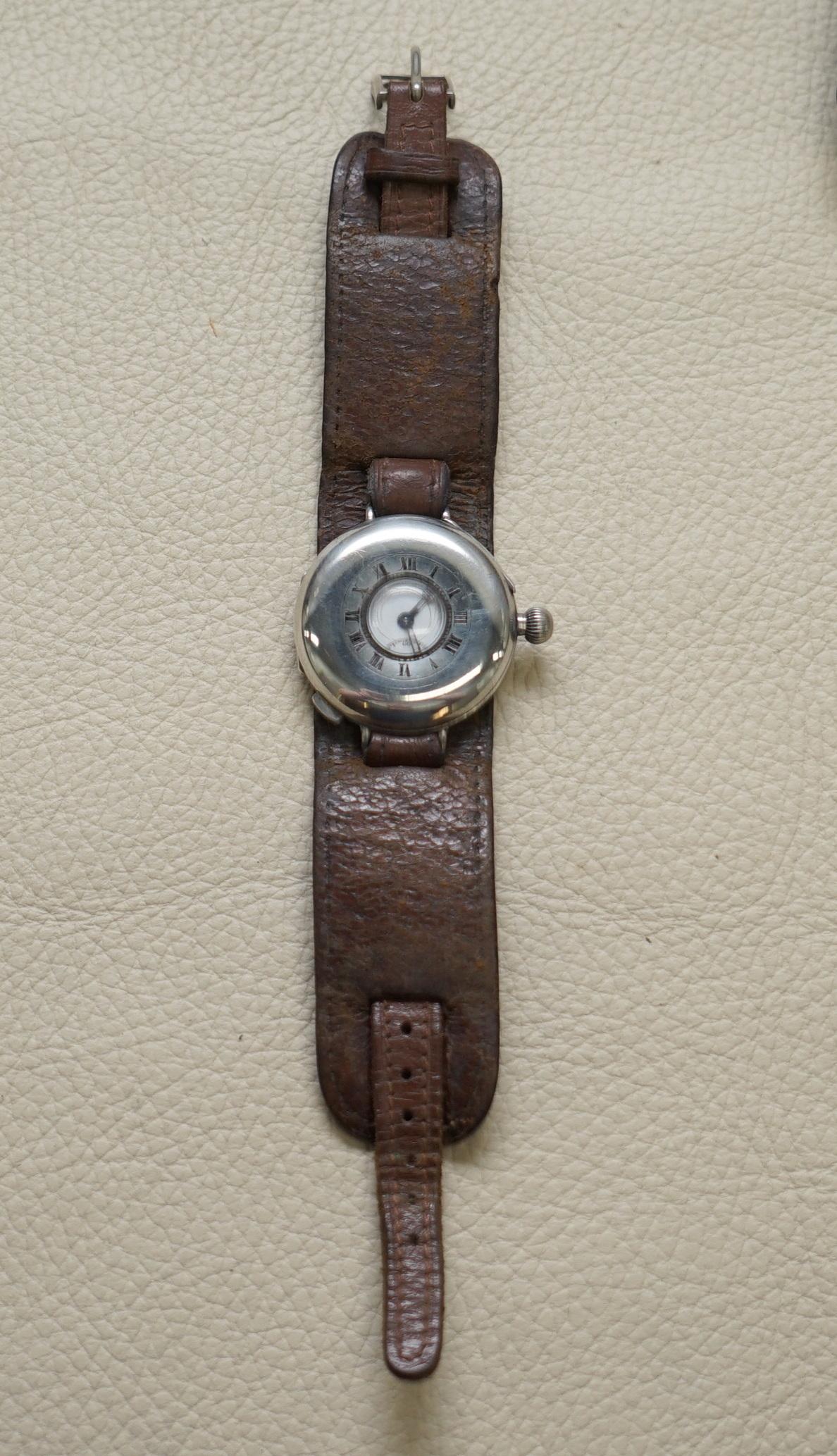 Wimbledon-Furniture

Wimbledon-Furniture is delighted to offer for sale this lovely antique Sterling Silver Aviators watch with half hunter case

A good looking well made and functioning wrist watch, the strap is an aviator brown leather circa 1920,