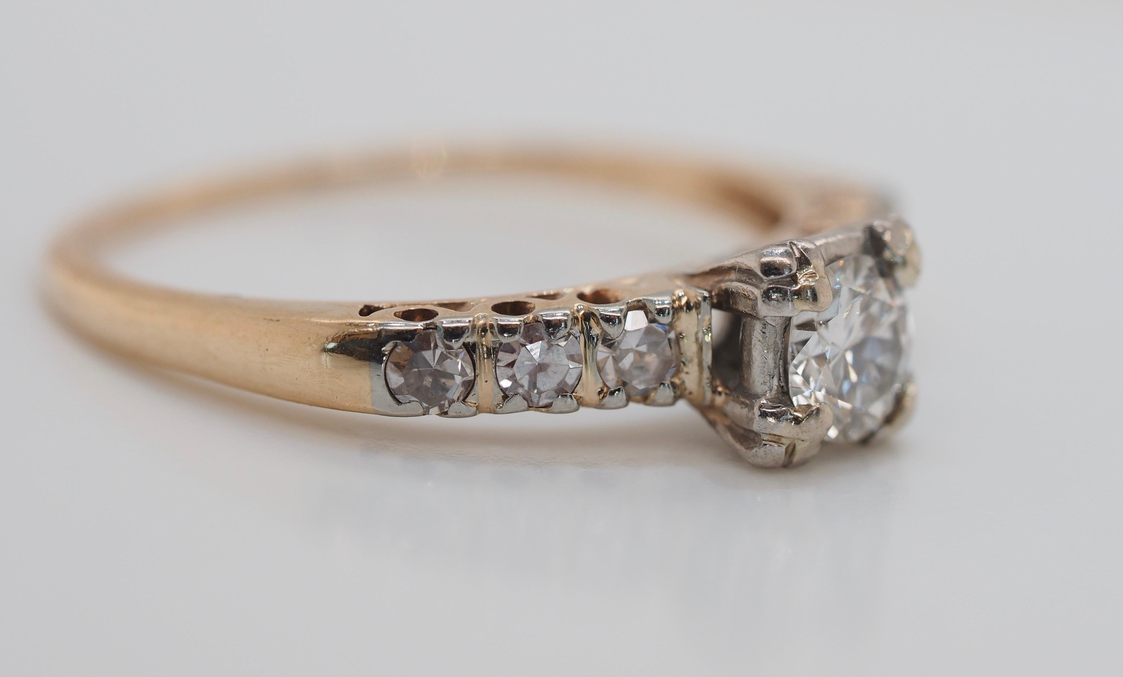 This ring is a perfect example of a classic Art Deco style featuring a stunning 1/3 carat brilliant cut center diamond set in fishtail prong settings, which were at the height of fashion during that era. This unique style made the center stone