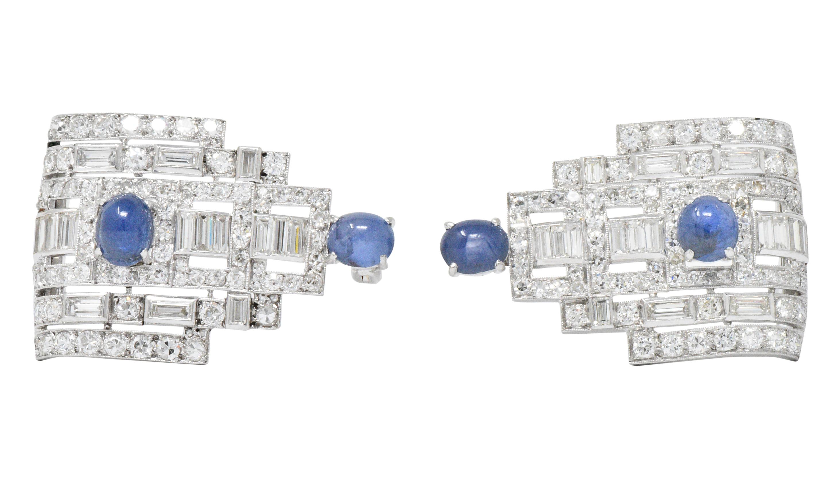 Two clips, each featuring 2 oval cabochon sapphires weighing approximately 5.95 carats total, bright medium blue

Set throughout with baguette, full and Swiss cut diamonds, weighing approximately 6.20 carats total, G/H color and VS to SI