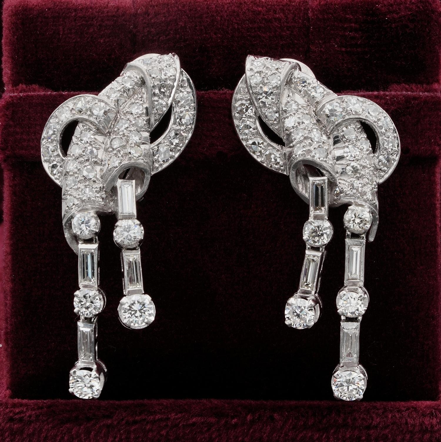 Look at me Appeal

Striking bold design from the art Deco period, 1925 ca, Platinum made
Bows of sparkling Diamonds with ribbon like cascade richly set with Diamonds
Classy from the Art Deco, wearable with discrete glam 
The intricate bows hold