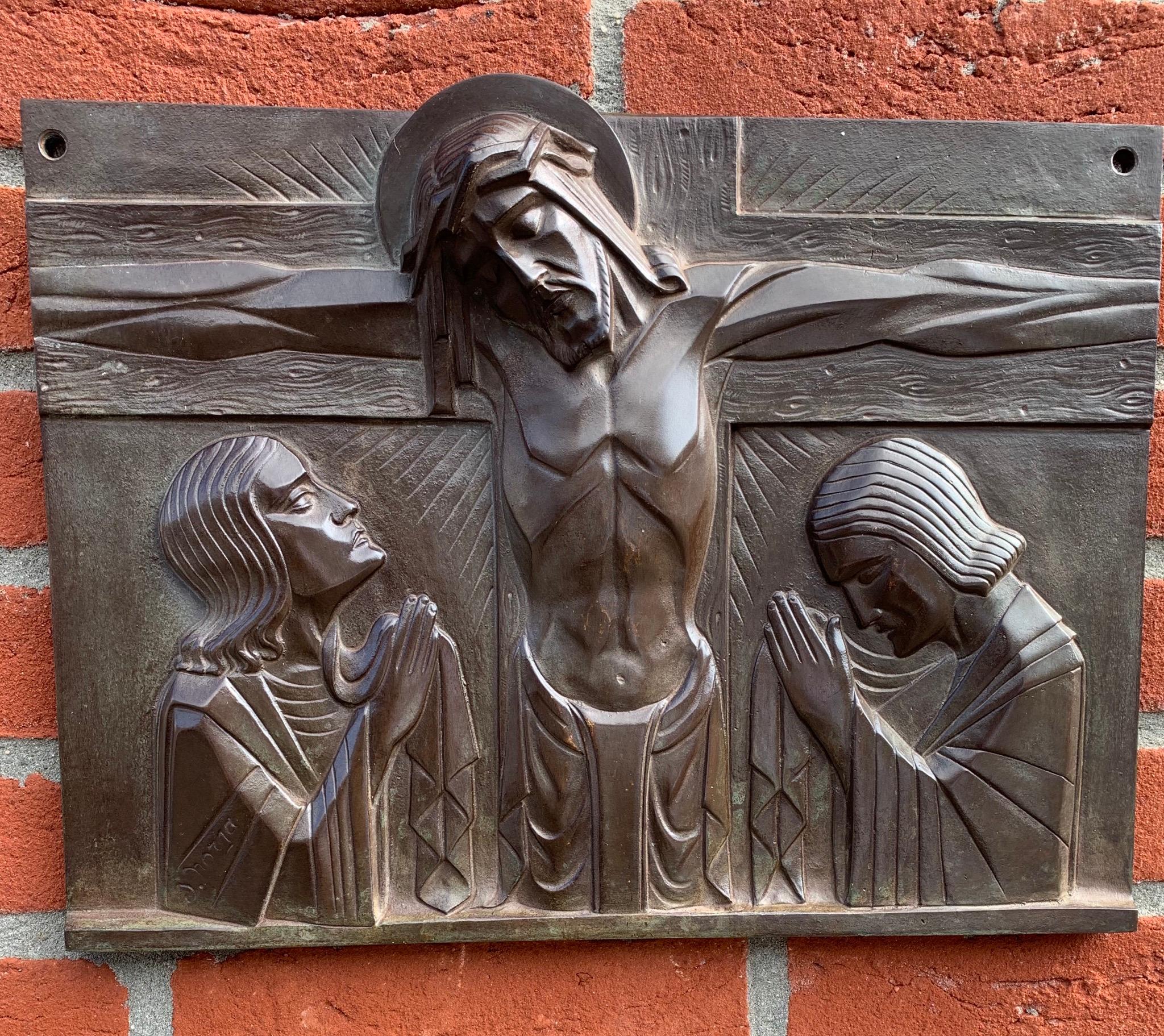 Perfectly stylized work of religious art by S. Norga.

This practical size and very good condition bronze plaque depicts Christ on the cross with Mary and Saint John mourning on either side. Sylvain Norga, known for his top quality religious art has
