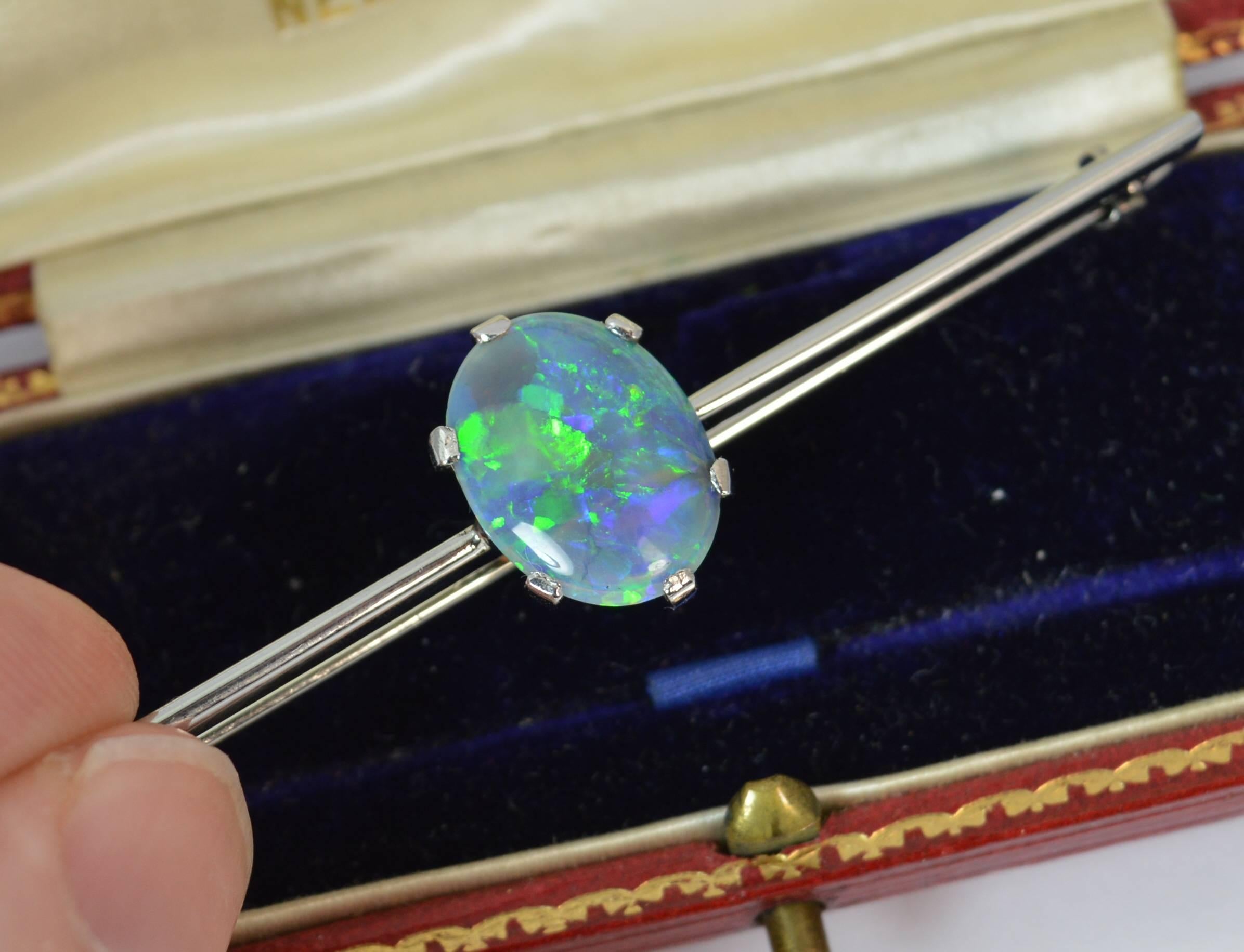 Platinum and oval Opal bar brooch in Platinum.

Stylish antique piece, true art deco period, c1920.

​Natural opal of stunning colour and contrast. Many blues and greens run through the stone with hints of yellows and reds.


Condition; Very good.