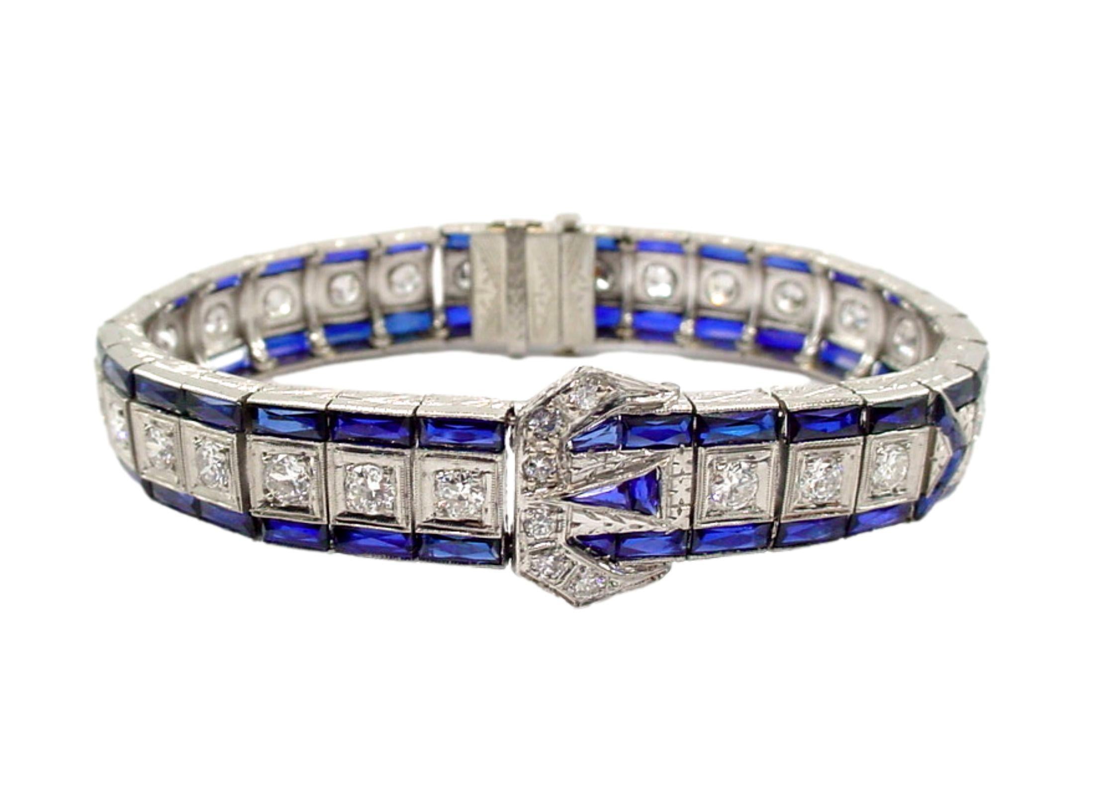 Iconic original Art Deco platinum line bracelet...

Rendered in sumptuous platinum and is chock full of diamonds and synthetic sapphires in a handsome buckle motif...

This beauty will accommodate a SMALL wrist size, length is 6 inches.

Weight is