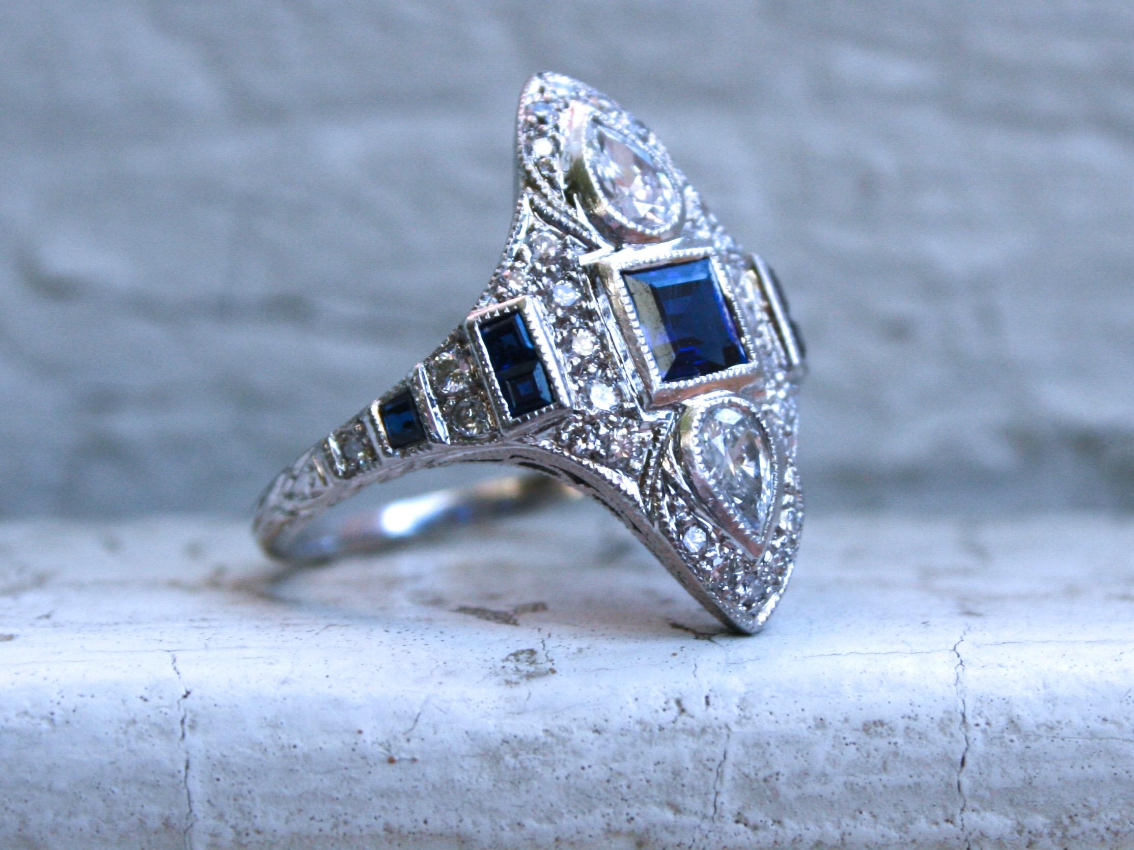 LOVE LOVE LOVE!! This Stunning Art Deco Style Diamond and Sapphire Navette Ring is just a masterpiece! Crafted in Platinum, this Deco Style Geometric design features Pave Diamonds, Fantastic Sapphires, great Pear Cut Diamonds, and amazing hand