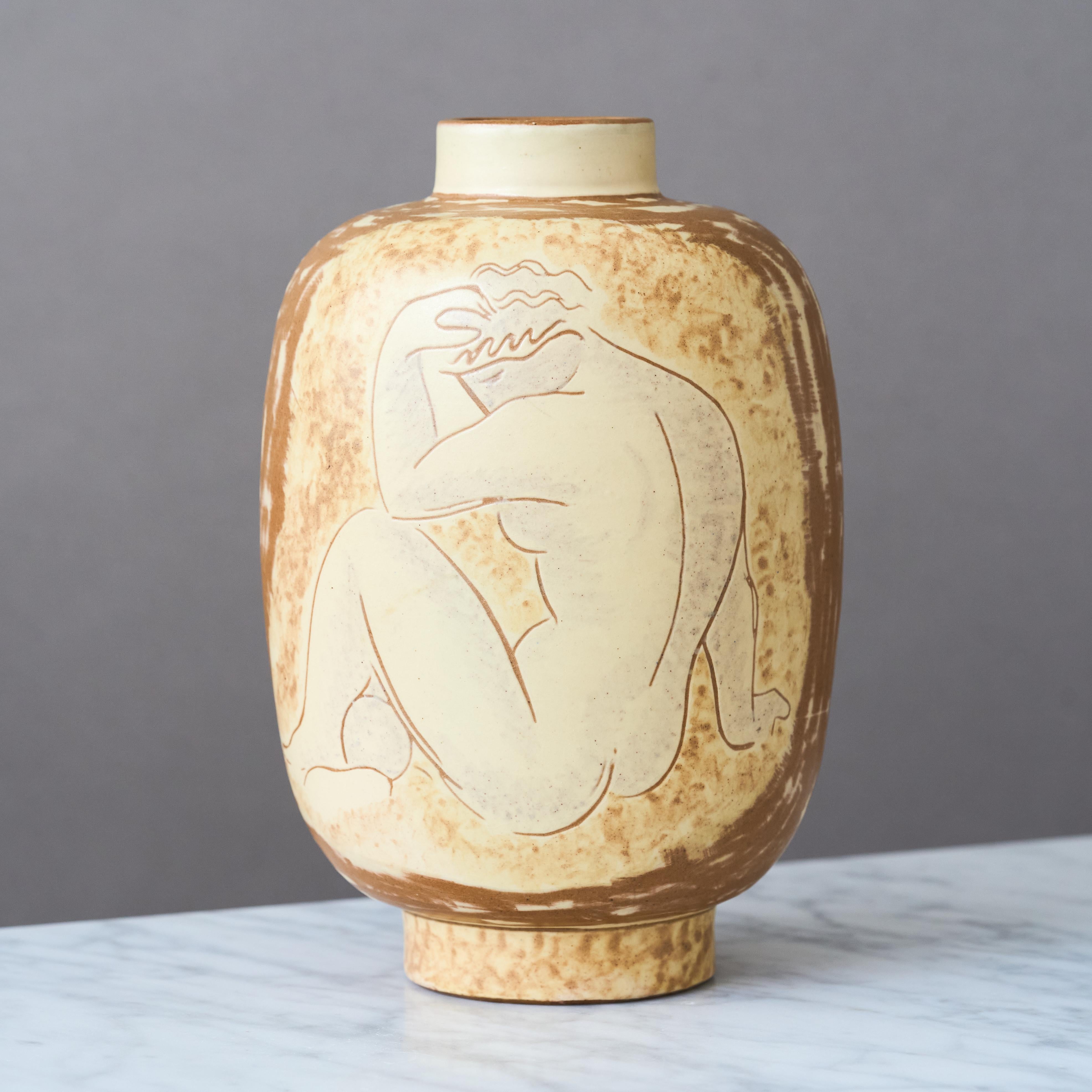 A beautiful and rare Art Deco / Swedish Grace earthenware vase with amazing decor depicting two female nude figures, each seated and with one arm resting on a knee.

Made by Vicke Lindstrand at Upsala-Ekeby, Sweden, 1943-44.

Excellent original