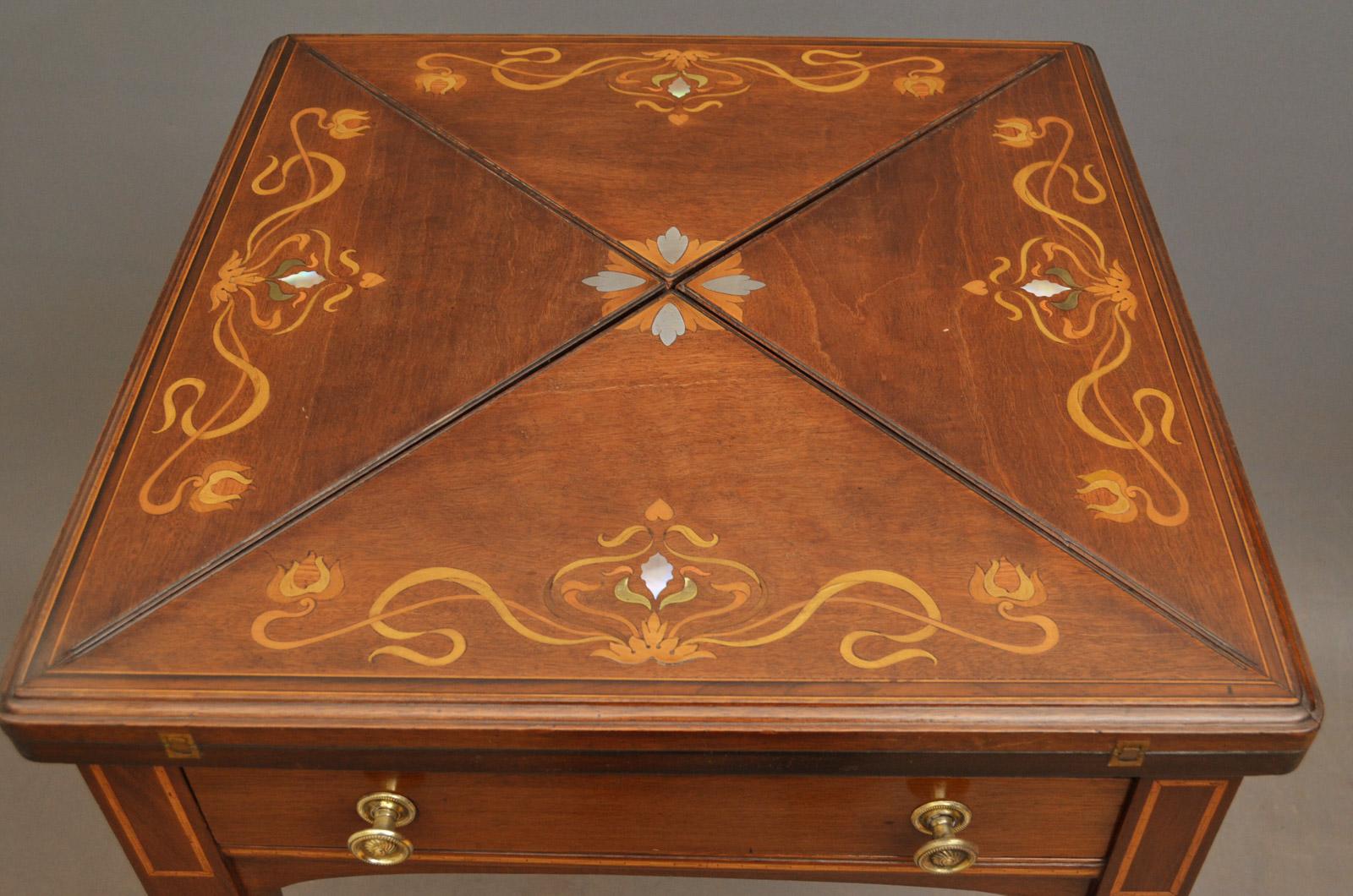 Sn3928, A beautiful Art Nouveau envelope card table in mahogany, having stylish multiwood and mother-of-pearl inlays to top with sinuous, which open to reveal baize playing surface with tooled gilt leather border, single drawer to frieze fitted with