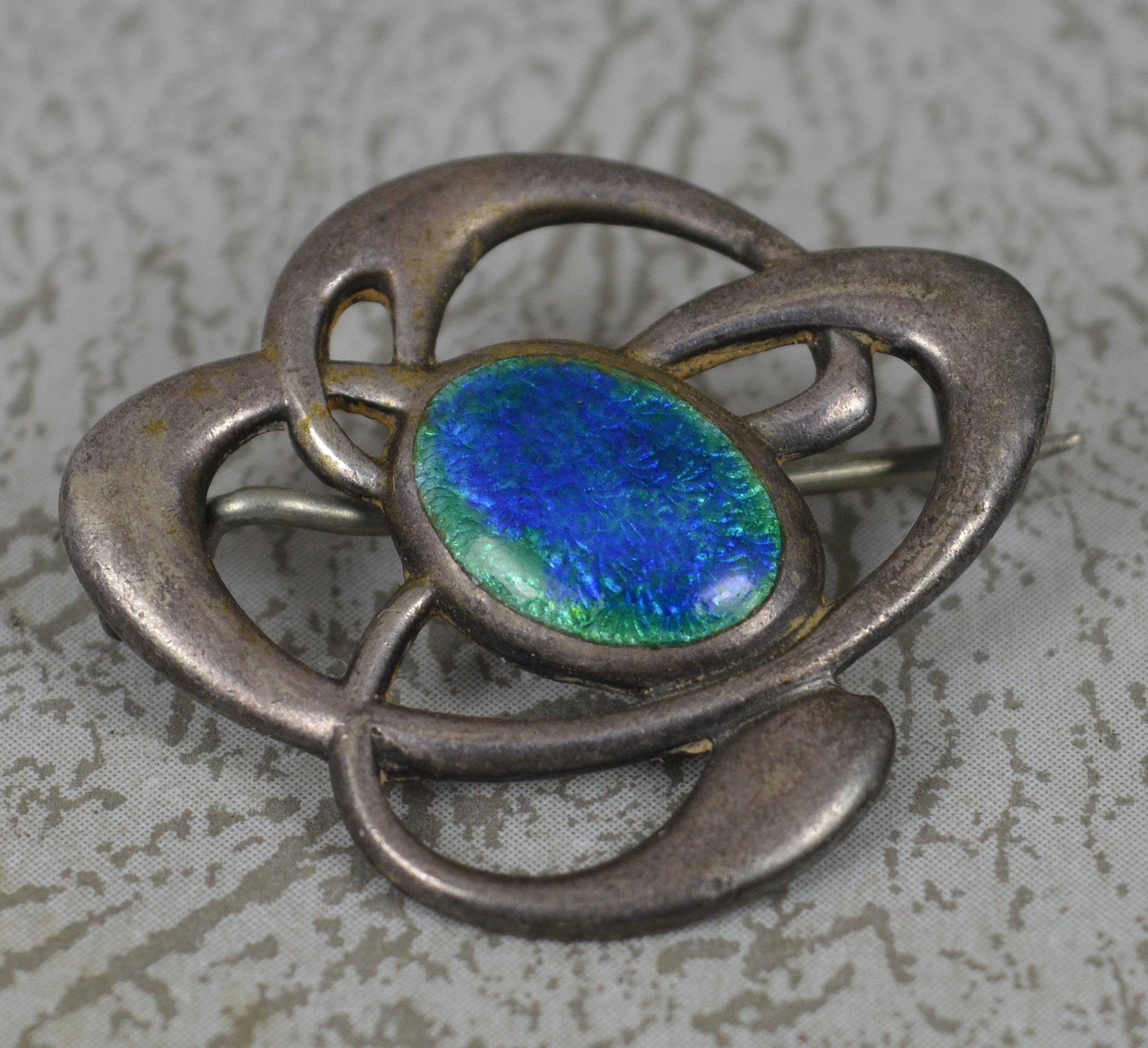A superb Edwardian period brooch.
Modelled in 925 sterling silver with large panel of the most iridescent blue/green enamelling.
4.0 grams.

Hallmarks ; full marks to reverse
Size ; 27mm x 23mm approx
Condition ; Very good for age. Crisp pattern and