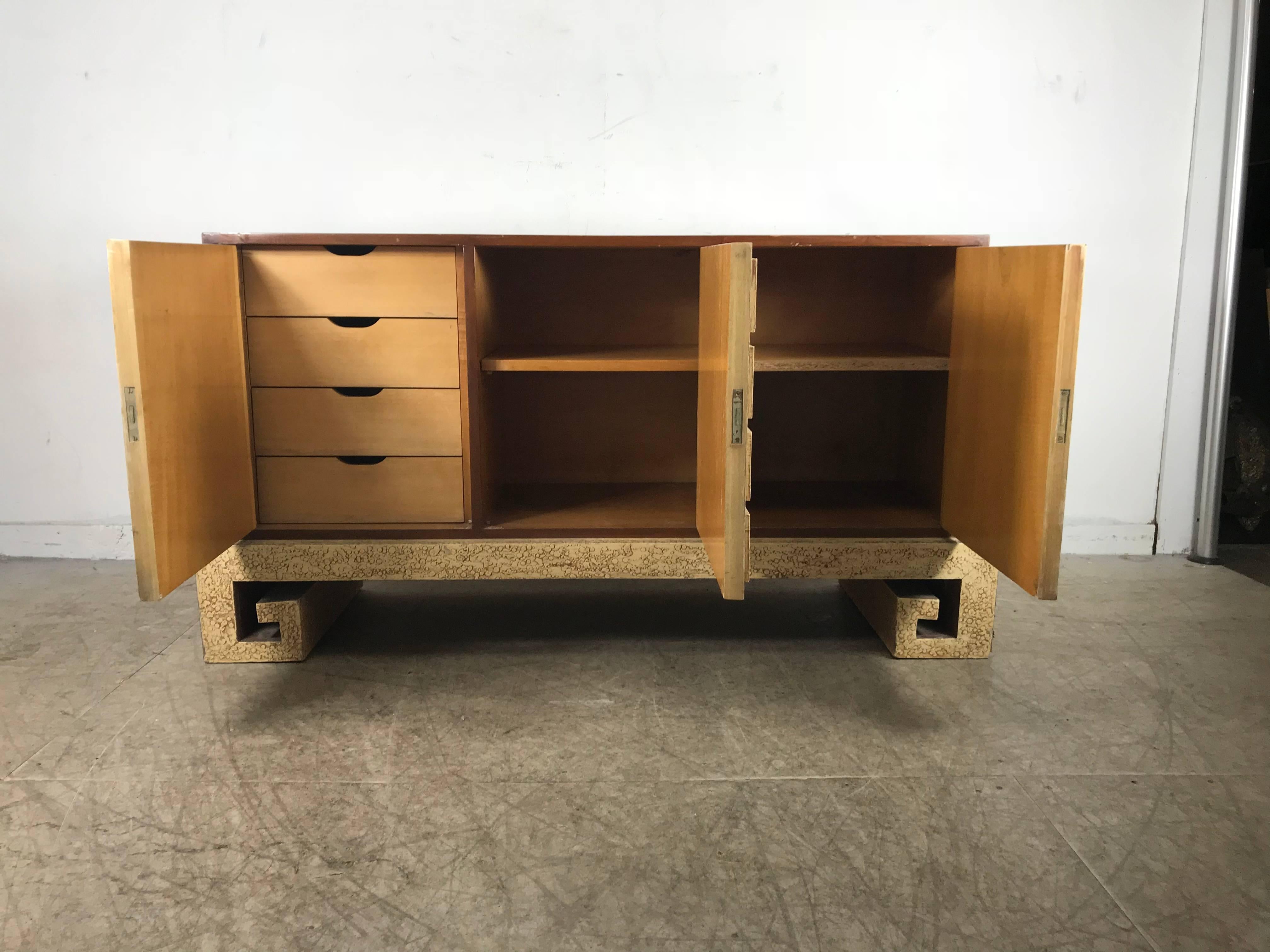 Stunning modernist Server, credenza manner of James Mont.. An Asian inspired server with carved fret work and textured oil spot lacquer surface, walnut top and surround, three doors and four drawers, hand delivery avail to New York City or anywhere