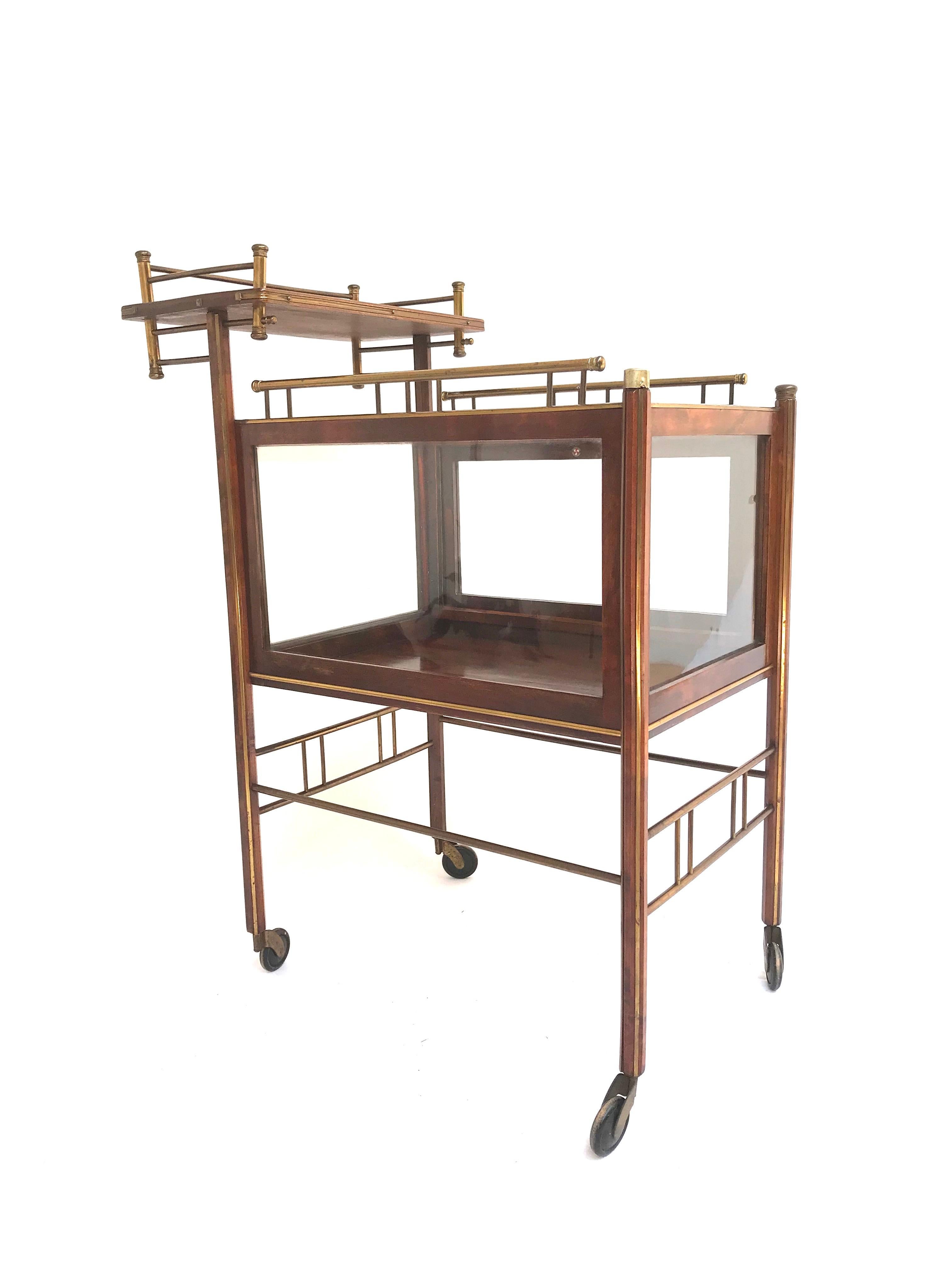 Modernist design Arts & Crafts drinks cart by Ernst Rockhausen of Waldheim, Germany.

Design-wise this one of a kind drinks trolley on its original wooden wheels is truly remarkable. The asymmetrical shape with its extra tier, for placing some