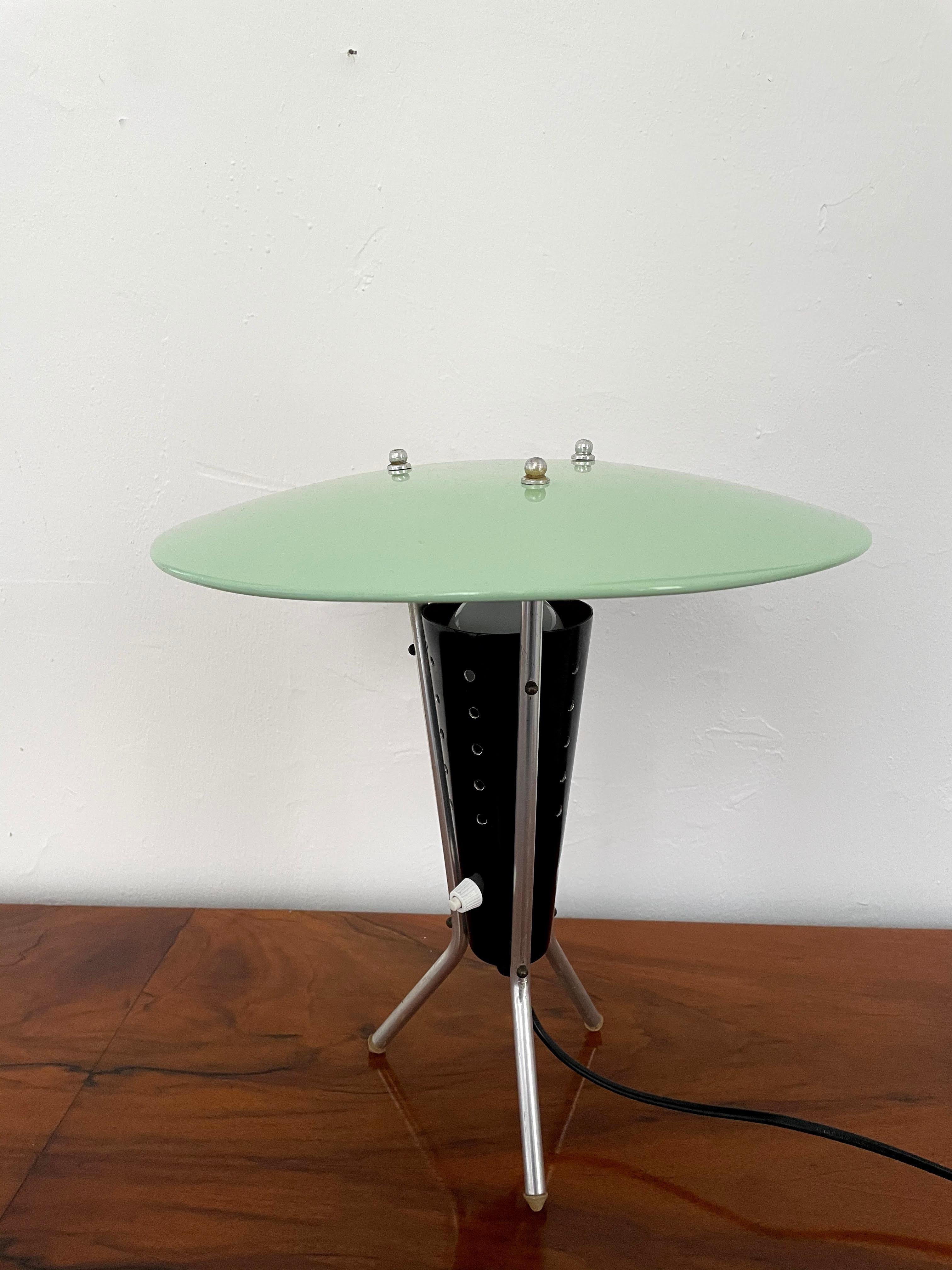 Stunning midcentury tripod table or desk lamp in brass and lacquered aluminium. The central black perforated cone houses the light source made soft indirect light. Very nice condition with a lovely patina and some loss of paint on the black cone.