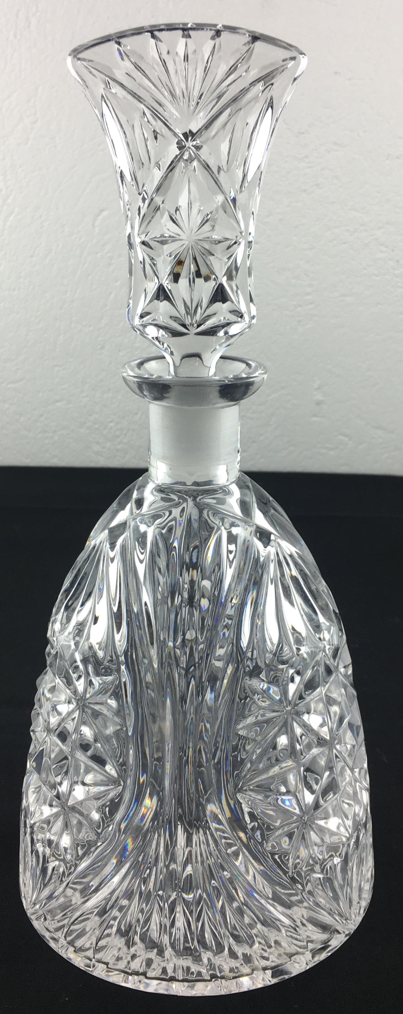 Exquisite Baccarat handcut crystal decanter with original bouchon and six liquor shot glasses. The liquor glasses were originally used for consuming calva from the Normandy region. However, they are perfect for any liquor of choice consumed in small