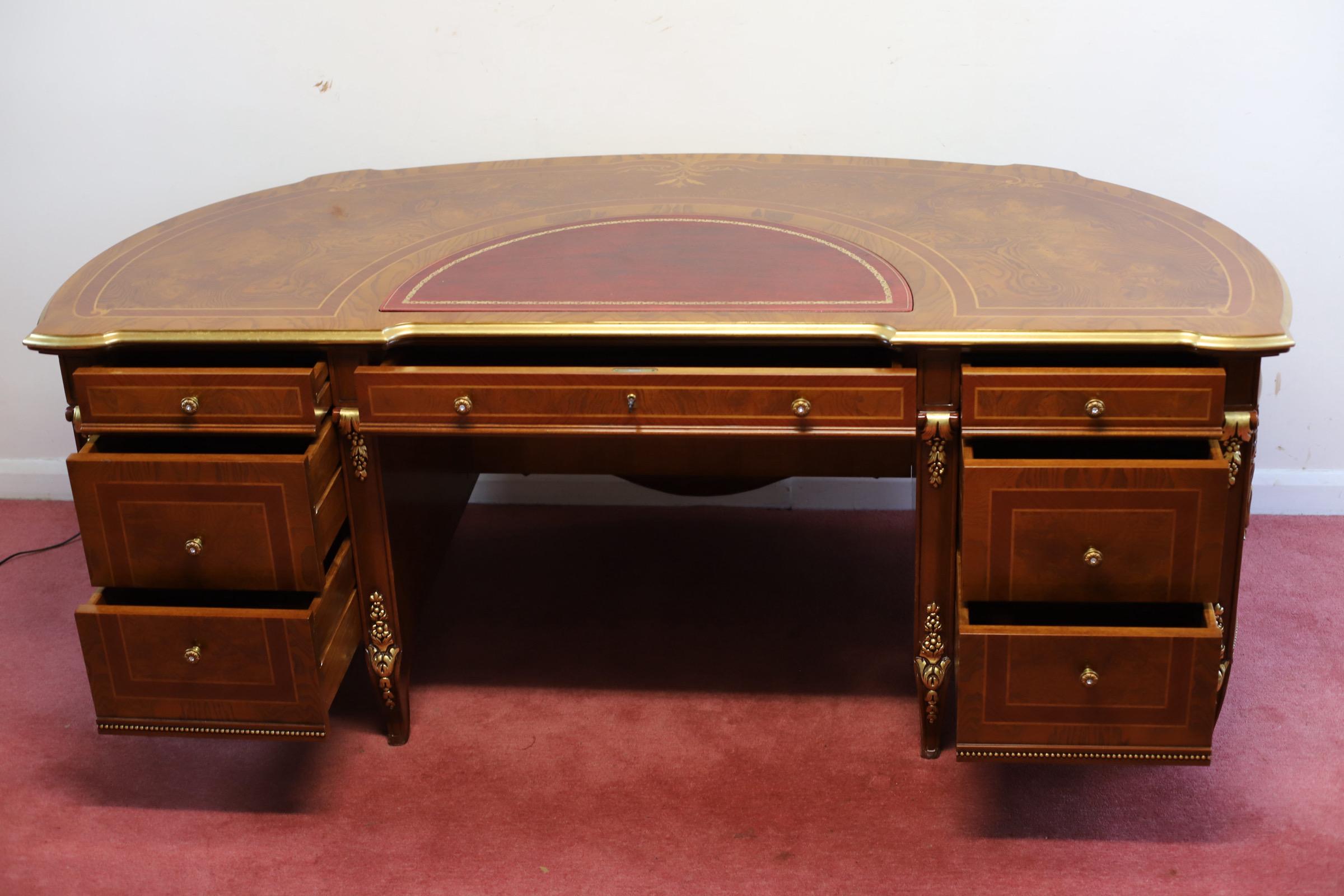 We delight to offer this amazing Barnini Oseo - large demi-lune ‘ Reggenza' desk, the banded top with satinwood foliate stringing and inset leather writing surface with gilt edge, fitted with central frieze drawer flanked by six graduating drawers,