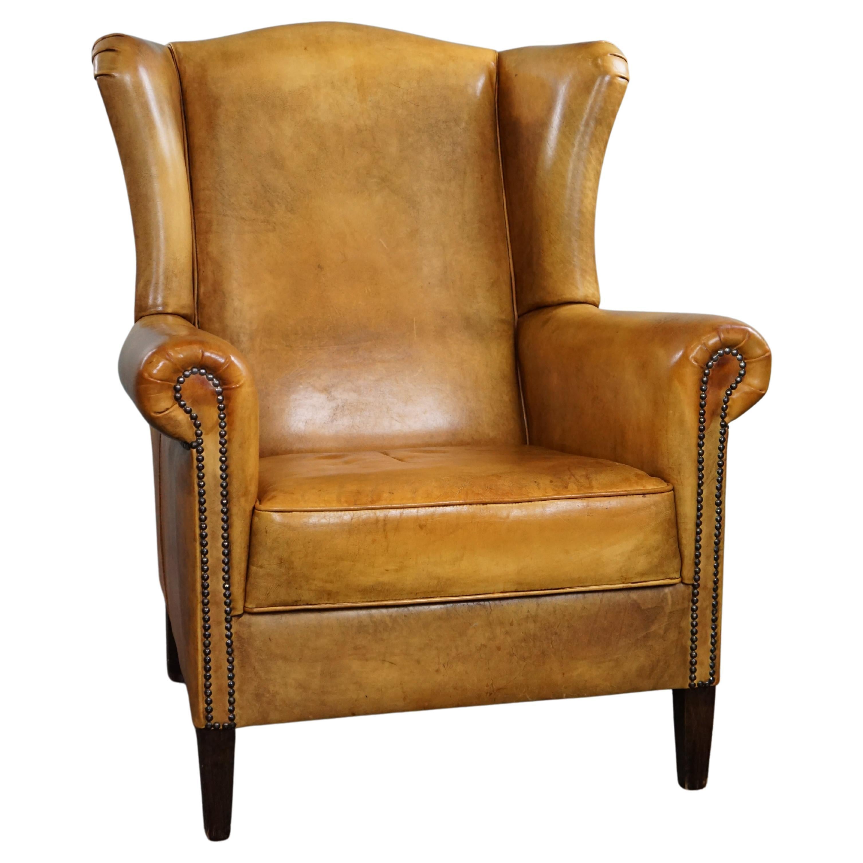 Superbe fauteuil à oreilles en cuir de vachette blond