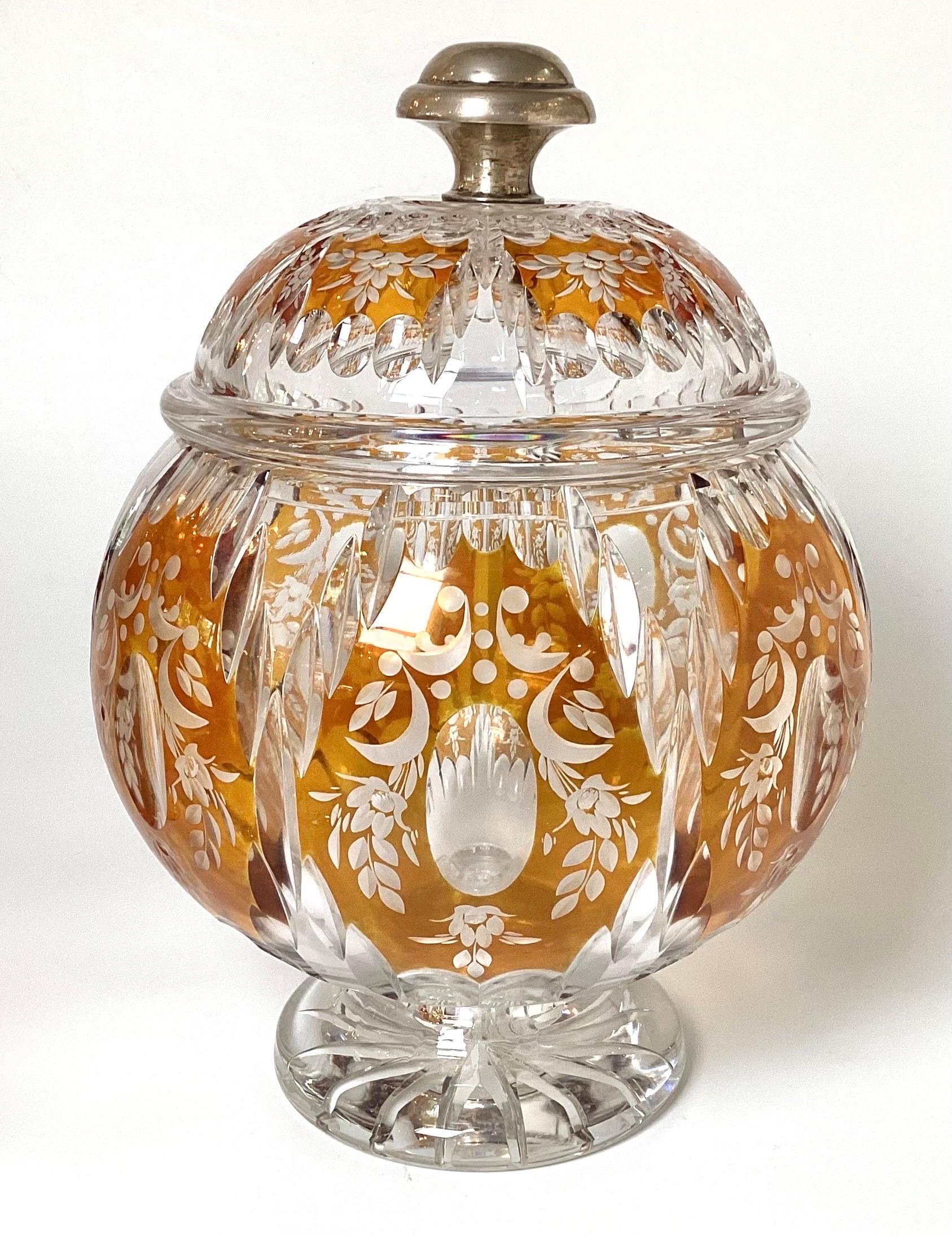 A beautiful amber cut to clear class covered punch bowl set with matching cups. The round bowl with lid with an 800 silver knob, with 10 original matching cups. the punch bowl measures 14 inches high, 10 inches diameter with the body in amber and