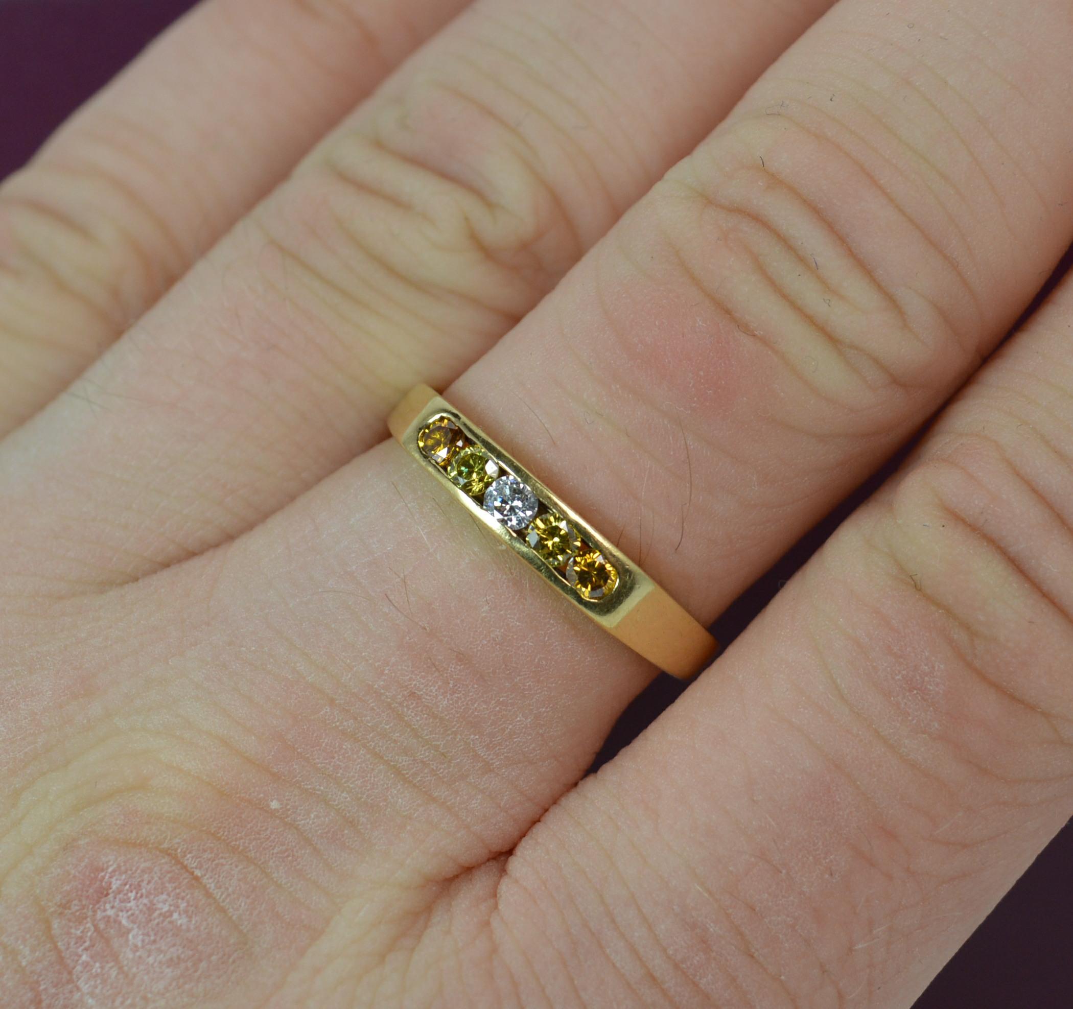 A fantastic Boodle and Dunthorne half eternity five diamond stack ring.
SIZE ; Q 1/2 UK, 8 1/4 US
Modelled in 18 carat yellow gold with five tension channel set diamonds.

The diamonds spread 13mm and consist of one white, two yellow and two orange