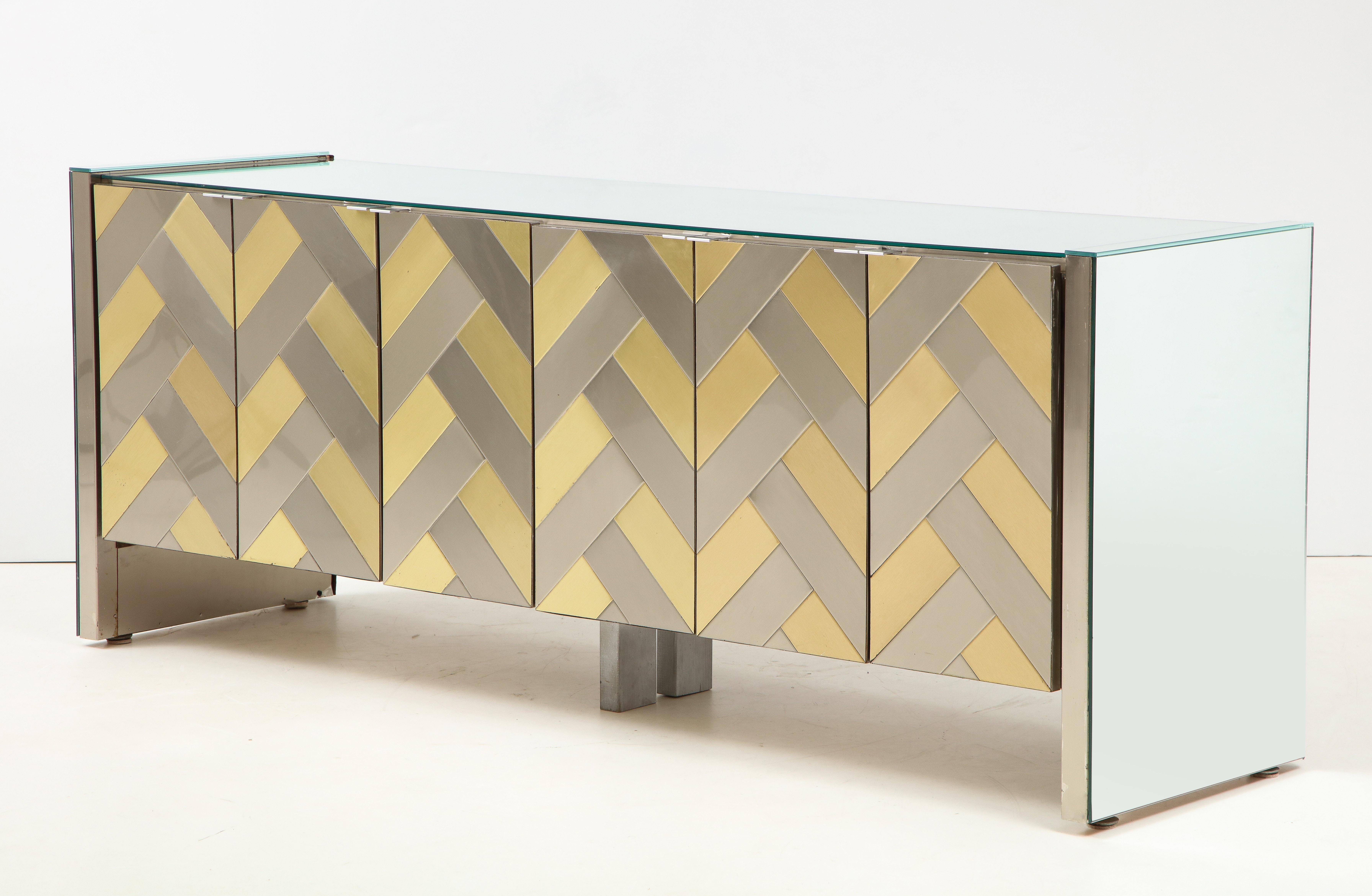 Stunning large brass and chrome chevron design cabinet by Ello.
The beautiful brass and chrome decor panels have a chevron design pattern with chrome pulls
that open to reveal six matching size drawers.
The top and sides of the cabinet are mirrored