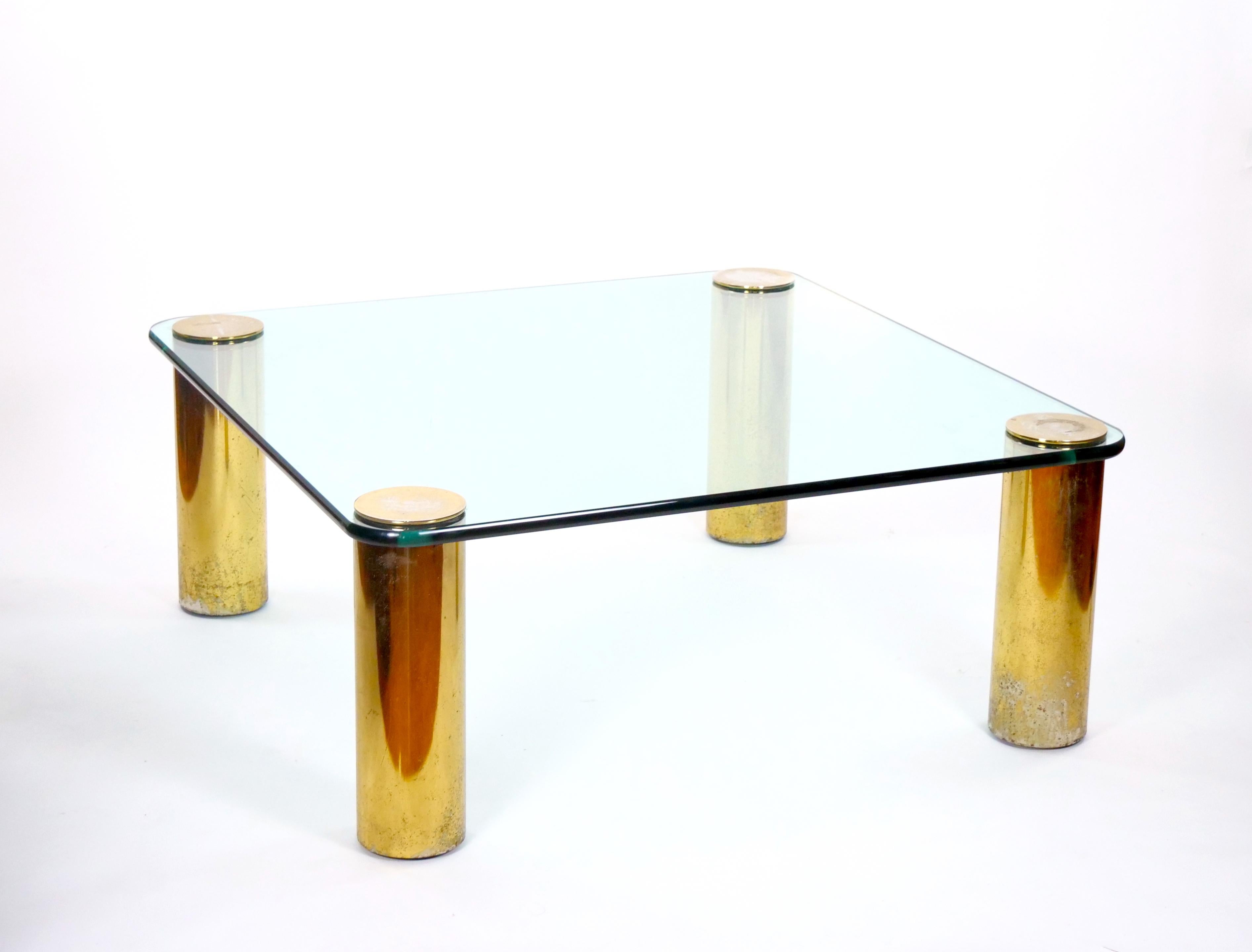 Introducing a stunning late 20th-century cocktail table that seamlessly embodies mid-century modern style, attributed to the prestigious Pace Collection. This exquisite piece features a heavy glass top gracefully balanced on four brass column pole