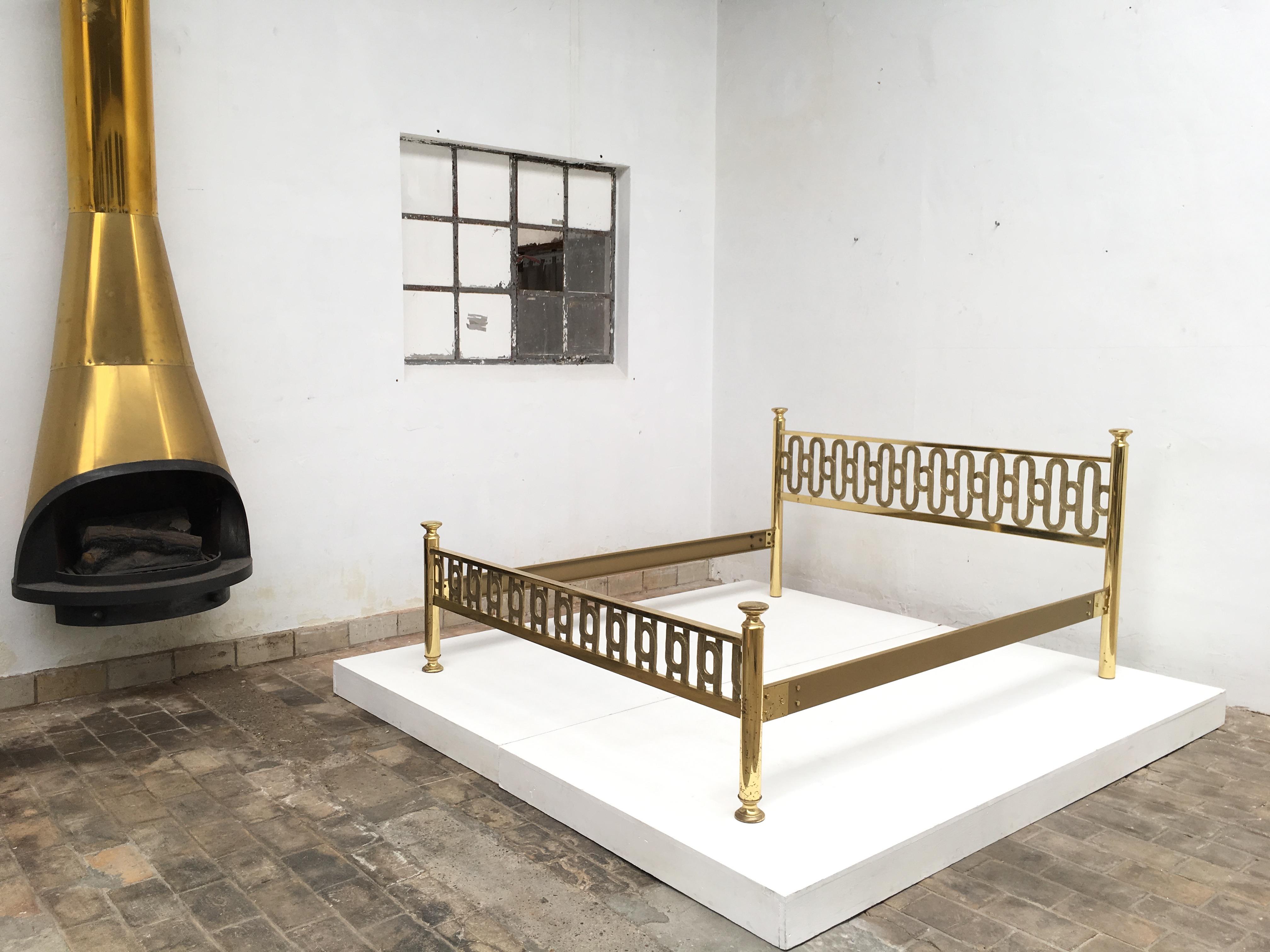 Beautifully crafted brass double bed by Italian artist Angelo Brotto. 
The headboard and foot rail feature a wonderful heavy brass sculptural form interlocking loop motif with incised detailing in excellent condition 
The two side rails are